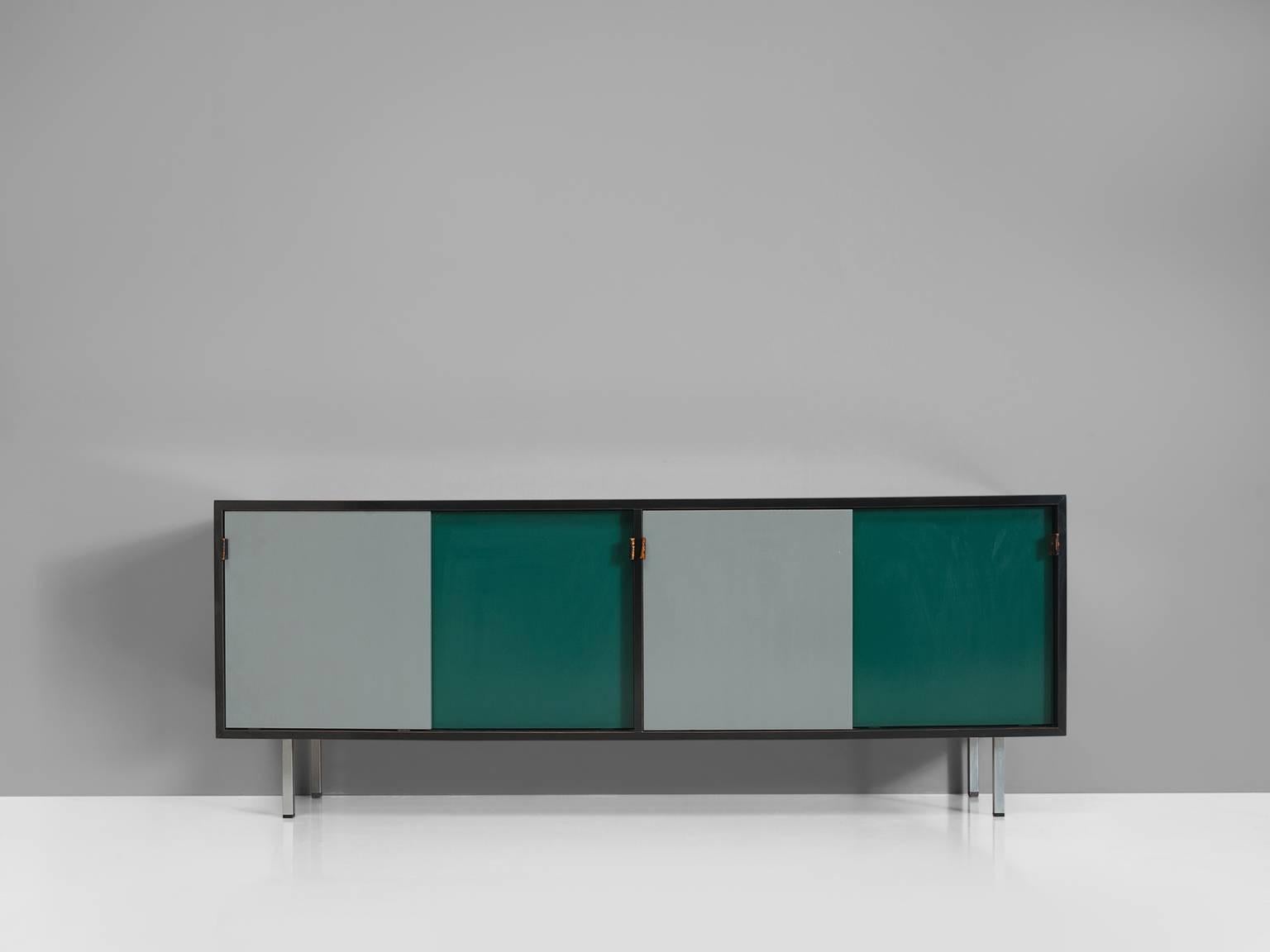 Sideboard, grey and green wood, metal feet, leather straps, France, 1960s.

This sideboard is designed and made by making use of colour blocks. The sideboard is executed in green and grey sliding doors that are framed by a black border. This