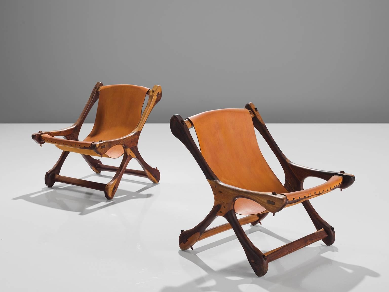 Don S. Shoemaker for Señal Furniture, set of two armchairs, in cocobolo and cognac leather, Mexico 1960s. 

Iconic pair of two swinger lounge chairs in Cocobolo rosewood and leather. These sling chairs have a characteristic organic shaped bone