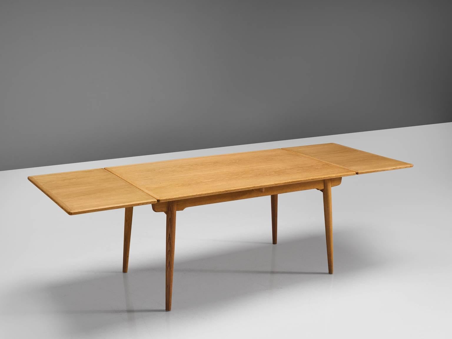 Hans J. Wegner for Andreas Tuck, 'AT-312', teak and oak, Denmark, 1950s.

This extendable AT-312 dining table designed by Hans J. Wegner is made from beech and has extra leaves in order to expand the piece from a six-seat (140cm) to a ten-seat