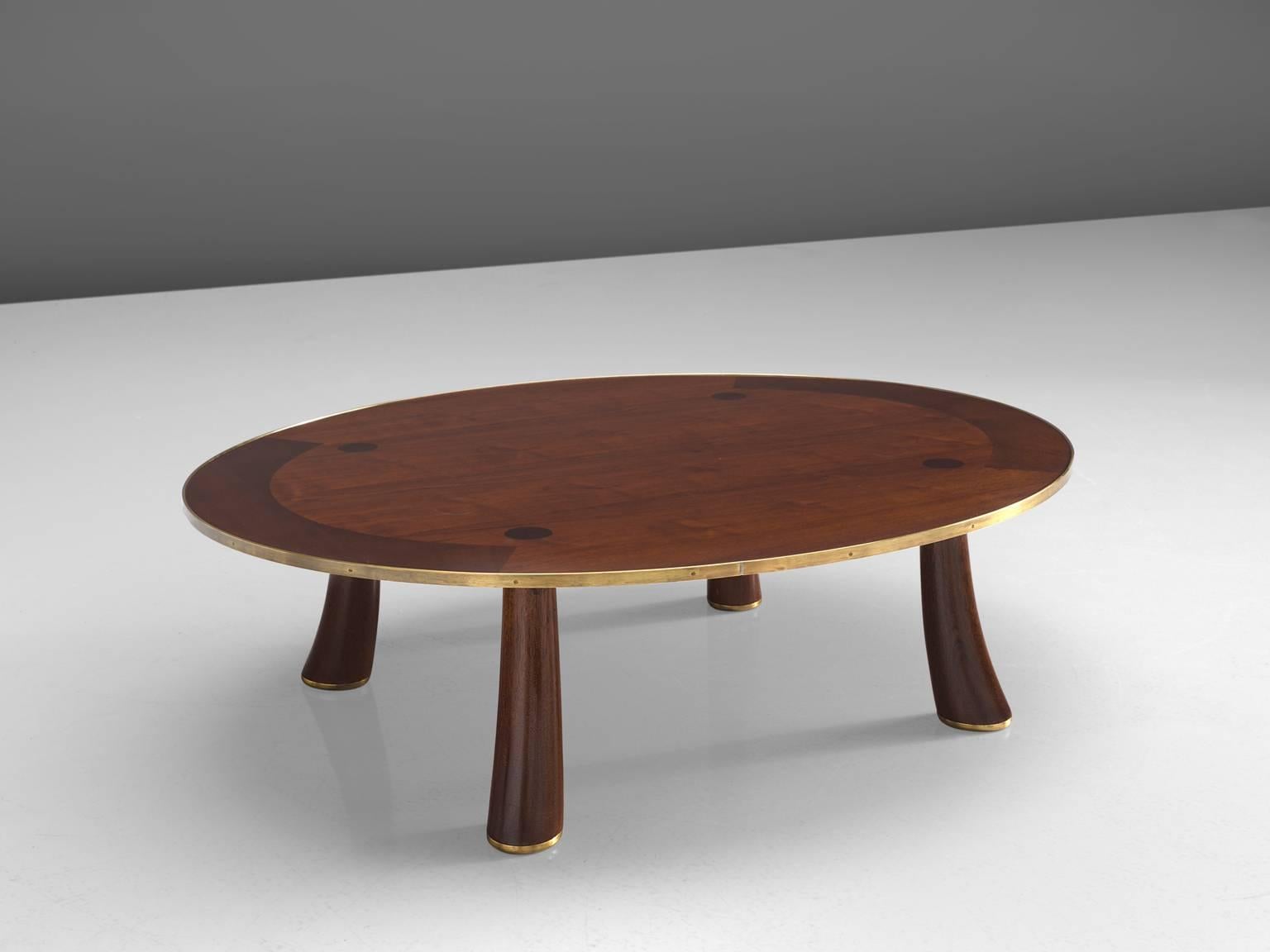 Dunbar coffee table, rosewood, brass, United States, 1950s

This oval coffee table is executed in the finest rosewood and shows delicate, crafted details in the slightly bent organic legs. The rim of the table is finished with brass and the legs