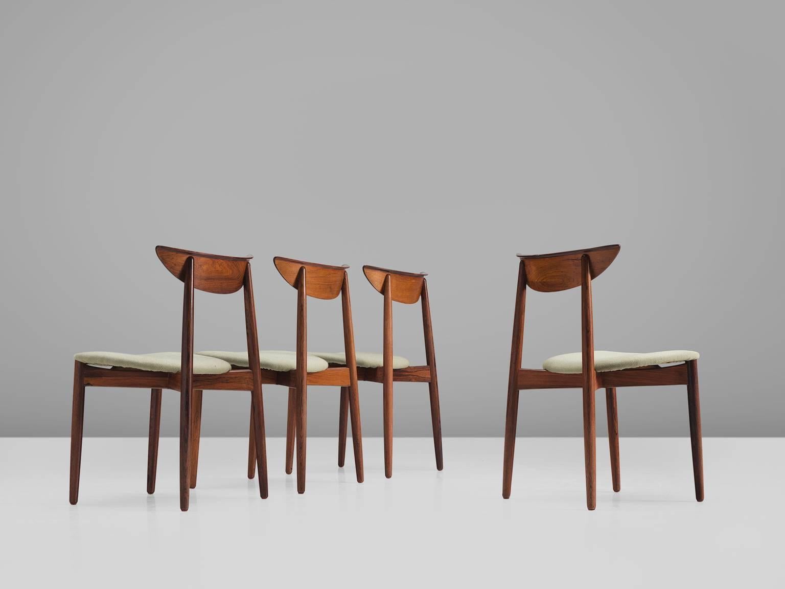 Harry Østergaard, set of four chairs, in rosewood and fabric, Denmark, 1950s. 

Set of four elegant rosewood dining room chairs. A simplistic design in beautiful grained and flamed wood that is especially visible on the curved back rest. These