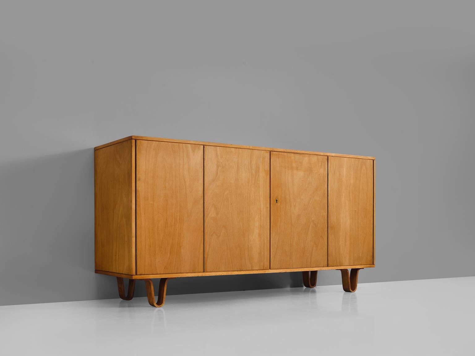 Cees Braakman for UMS Pastoe, sideboard model DB 02, birchwood veneer, Netherlands, 1950s.

This cabinet is executed in birch veneer and is designed by Cees Braakman for Pastoe. The distinctive feature of this four-door highboard is the theatrical