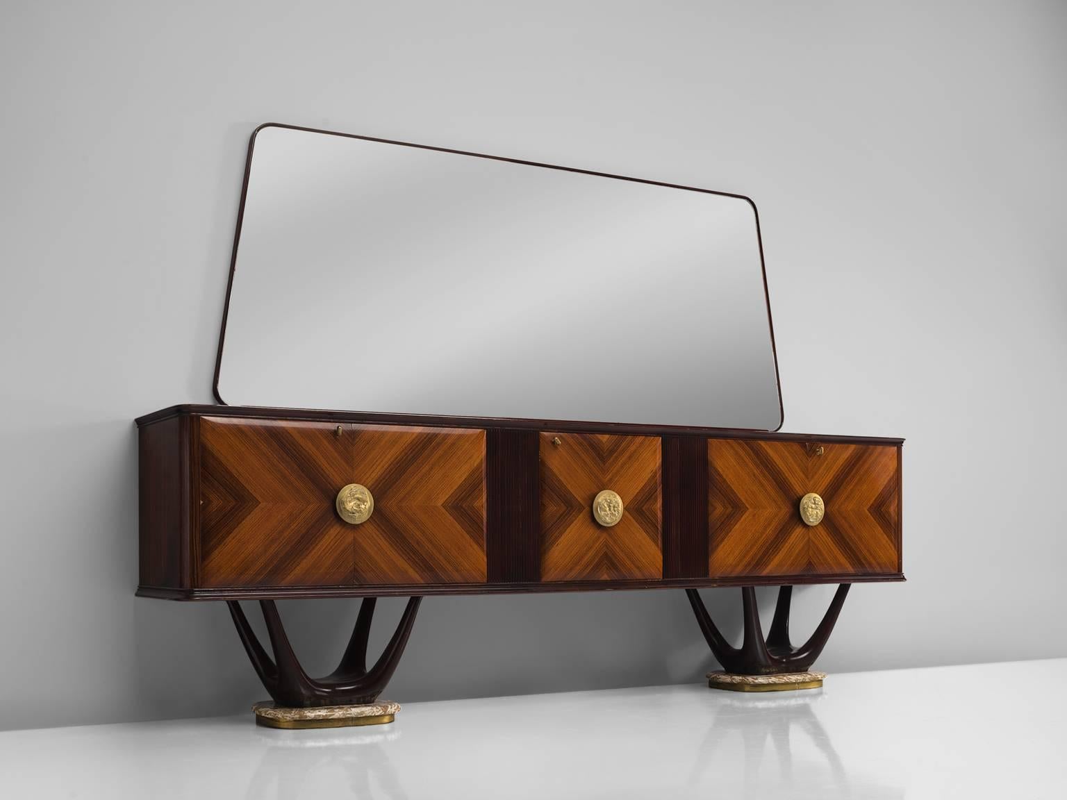 Fratelli Turri, sideboard, in mahogany, rosewood, maple, marble, glass and brass, Italy, 1950s.

This theatrical credenza features a large mirror in the style of Vittorio Dassi. The cabinet itself is made of a mahogany construction. The doors are