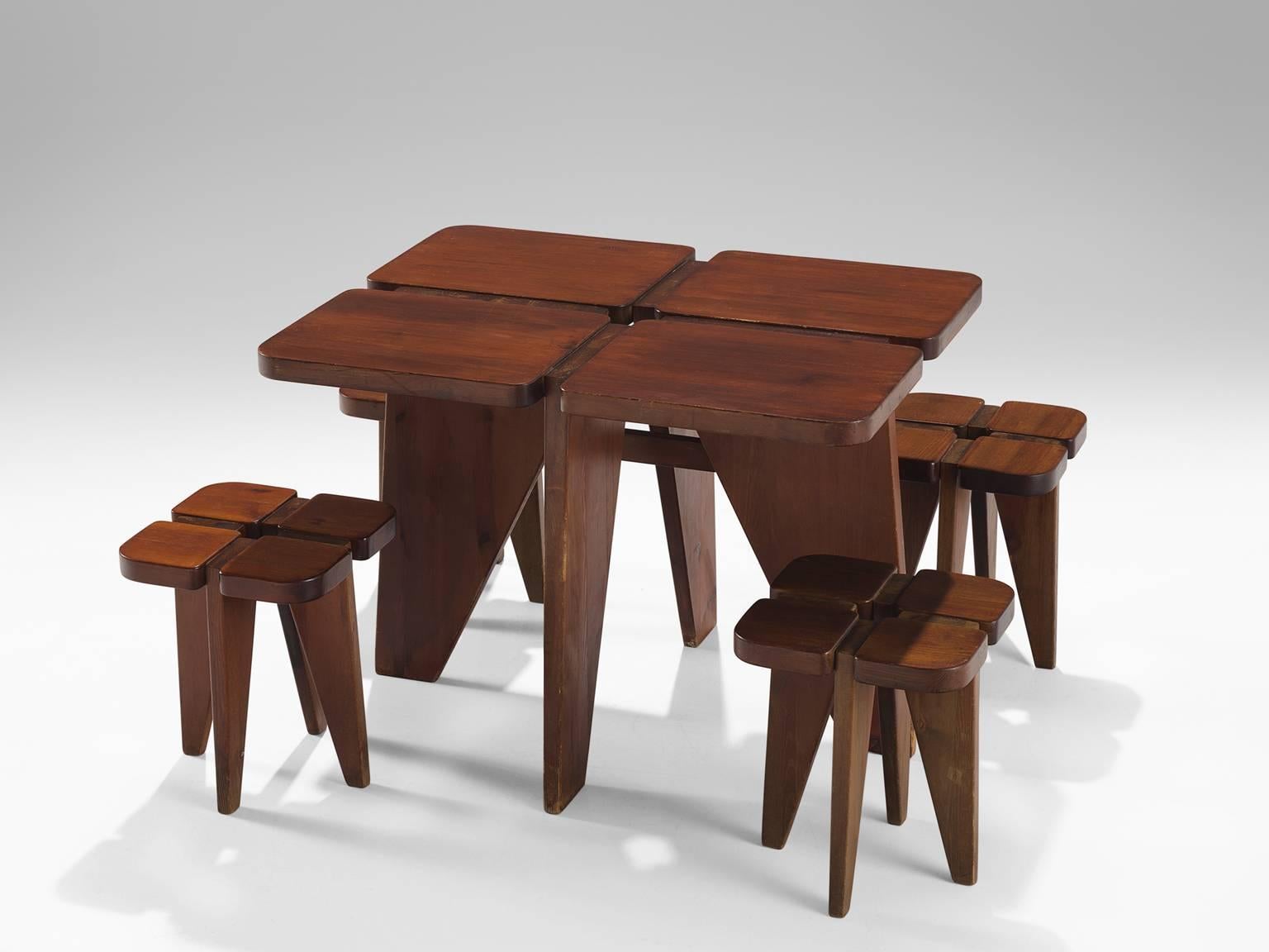 Lisa Johansson-Pape for Stockman Orno, table with stools, in stained pinewood, Finland, 1960s. 

This Finnish dining room set in dark stained pine consists of one table and four stools that all feature a clover-like top. The stools are an exact copy