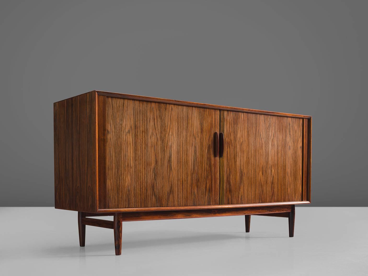 Arne Vodder for Sibast, rosewood, Denmark, 1960s.

This small rosewood sideboard is designed by Arne Vodder and is part of the midcentury design collection. The main features of this otherwise simple and modest cabinet are the flames and grain in