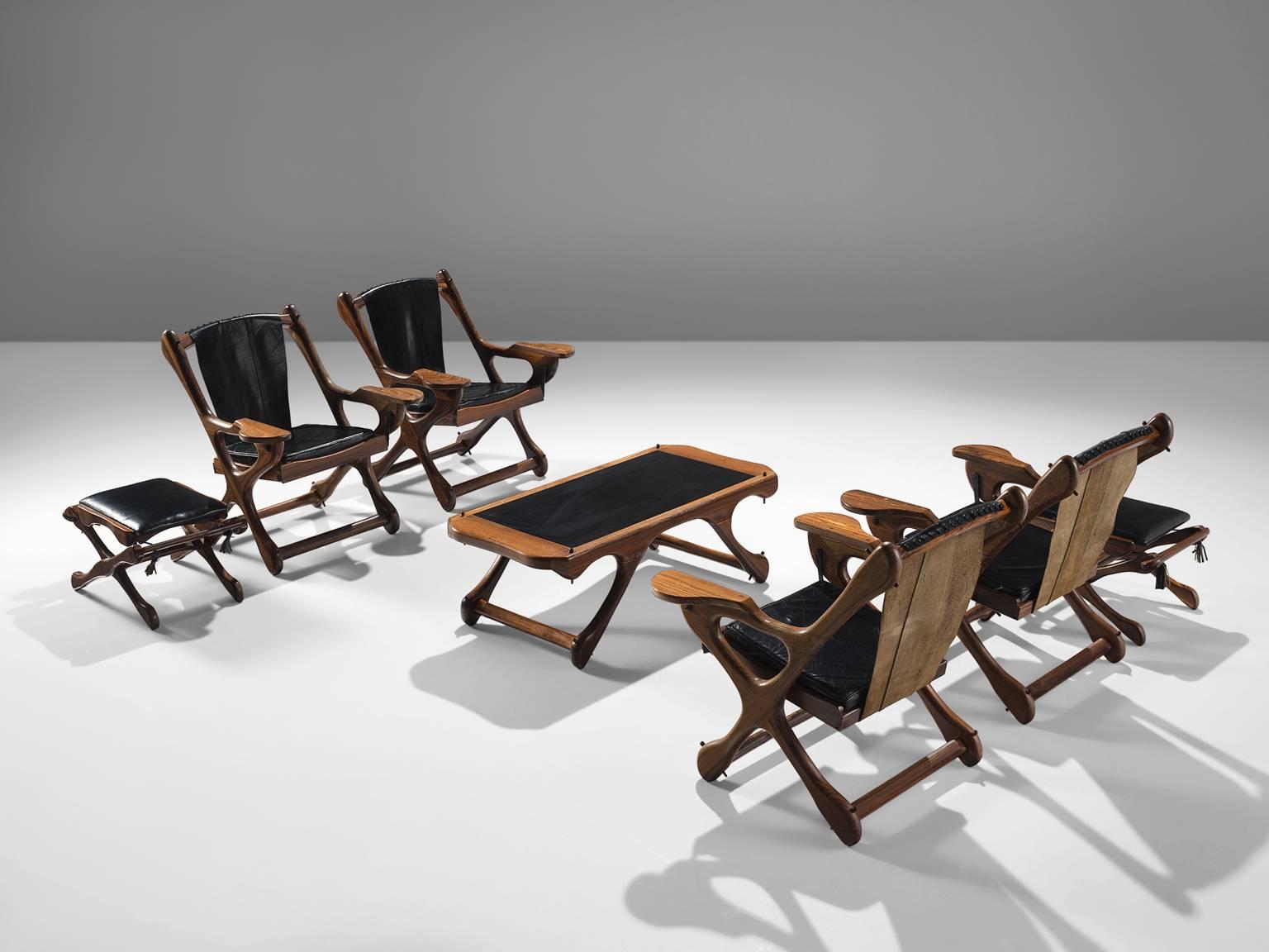 Don S. Shoemaker for Señal Furniture, set of two armchairs, in cocobolo and black leather, Mexico, 1960s. 

This iconic set of four swinger lounge chairs are executed in Cocobolo rosewood and leather.. The chairs are accompanied by a coffee and side