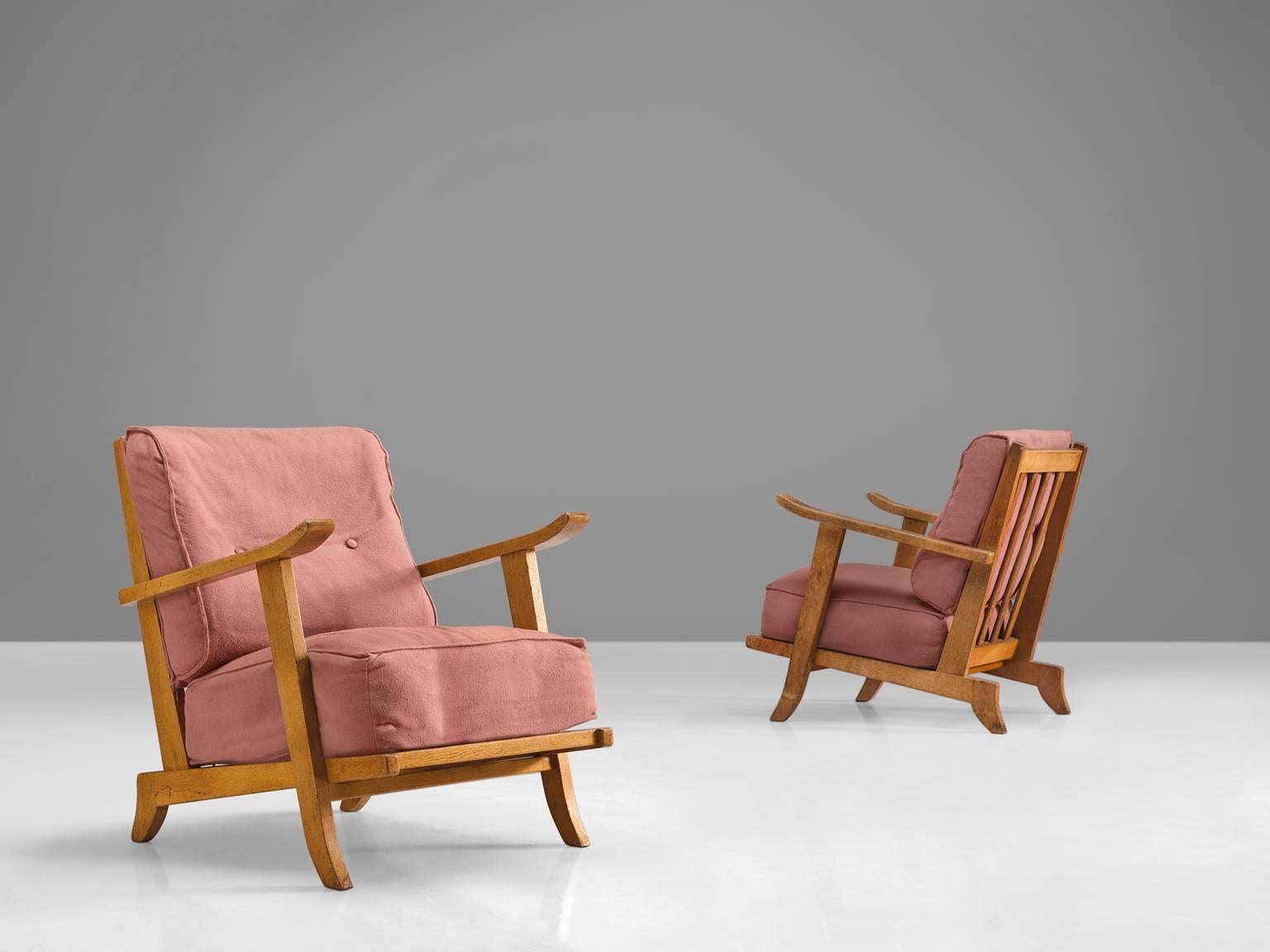 Easy chairs, pink fabric, oak,, France, 1950s

These sculptural easy chairs are part of the midcentury design collection. The chairs are executed out of high quality solid oak. These comfortable armchairs have an interesting open construction, with