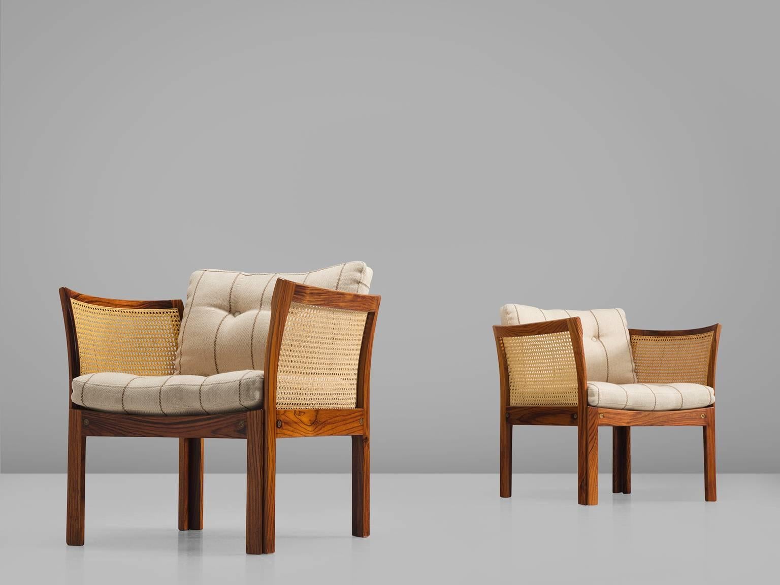 Illum Wikkelsø for C. F. C., Silkeborg, 'Plexus', rosewood, cane and white striped wool, Denmark, 1950s

This set of easy chairs by Illum Wikkelsoø is part of the midcentury design collection. The chairs most distinctive feature are the rosewood arm
