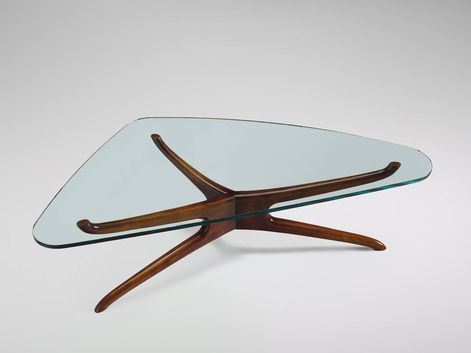 Vladimir Kagan, side table, walnut, glass, United States, 1960s.

This sculptural cocktail table by Vladimir Kagan is part of the midcentury design collection. The flowing, organic base is topped with a biomorphic glass top. The three-legged
