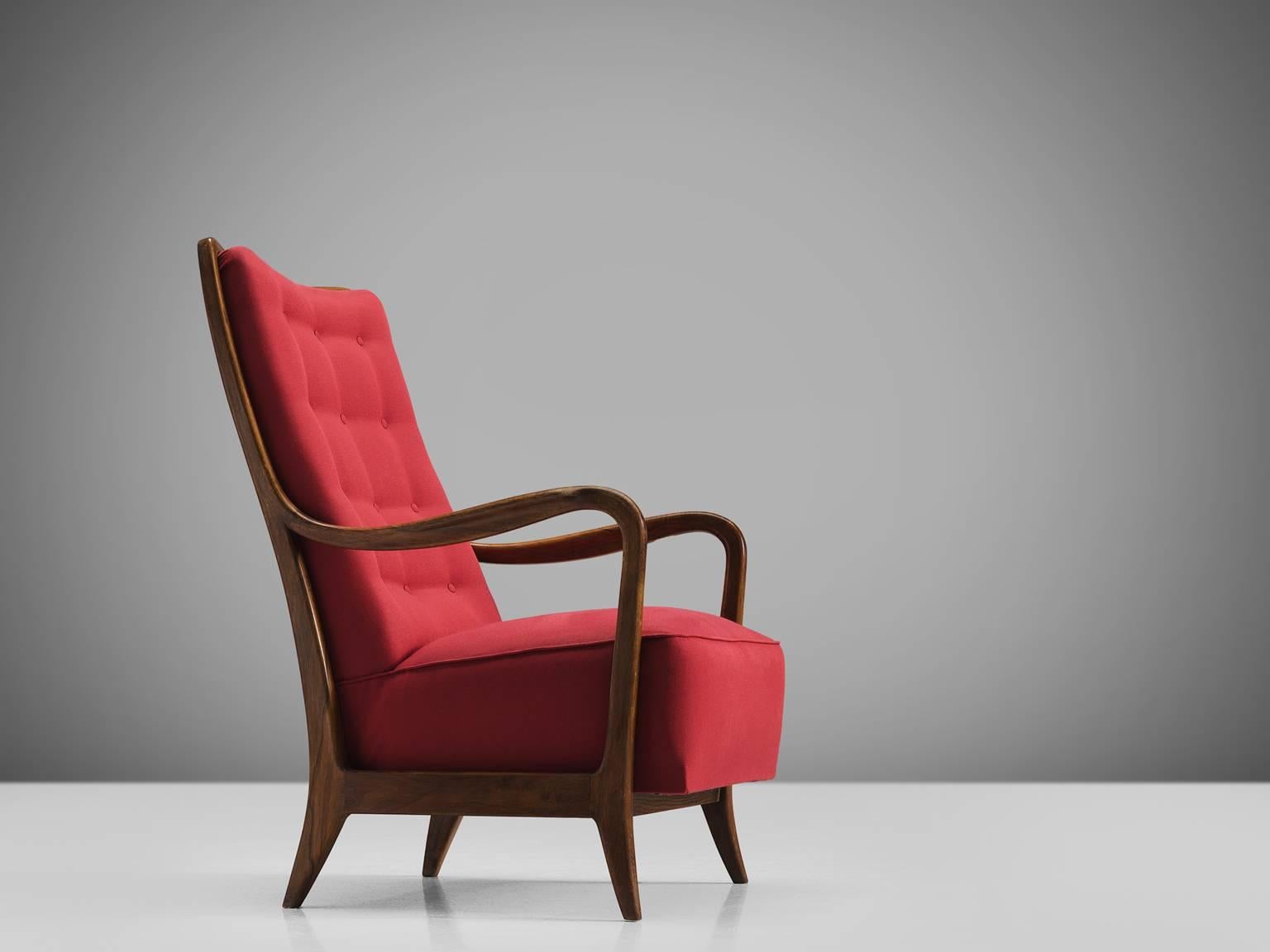 Cassina, easy chair in walnut and red fabric, Italy 1950s.

This Italian armchair in walnut is part of the midcentury design collection. The chair features curves and gracious forms. The small feet bent slightly outwards and the armrests make a