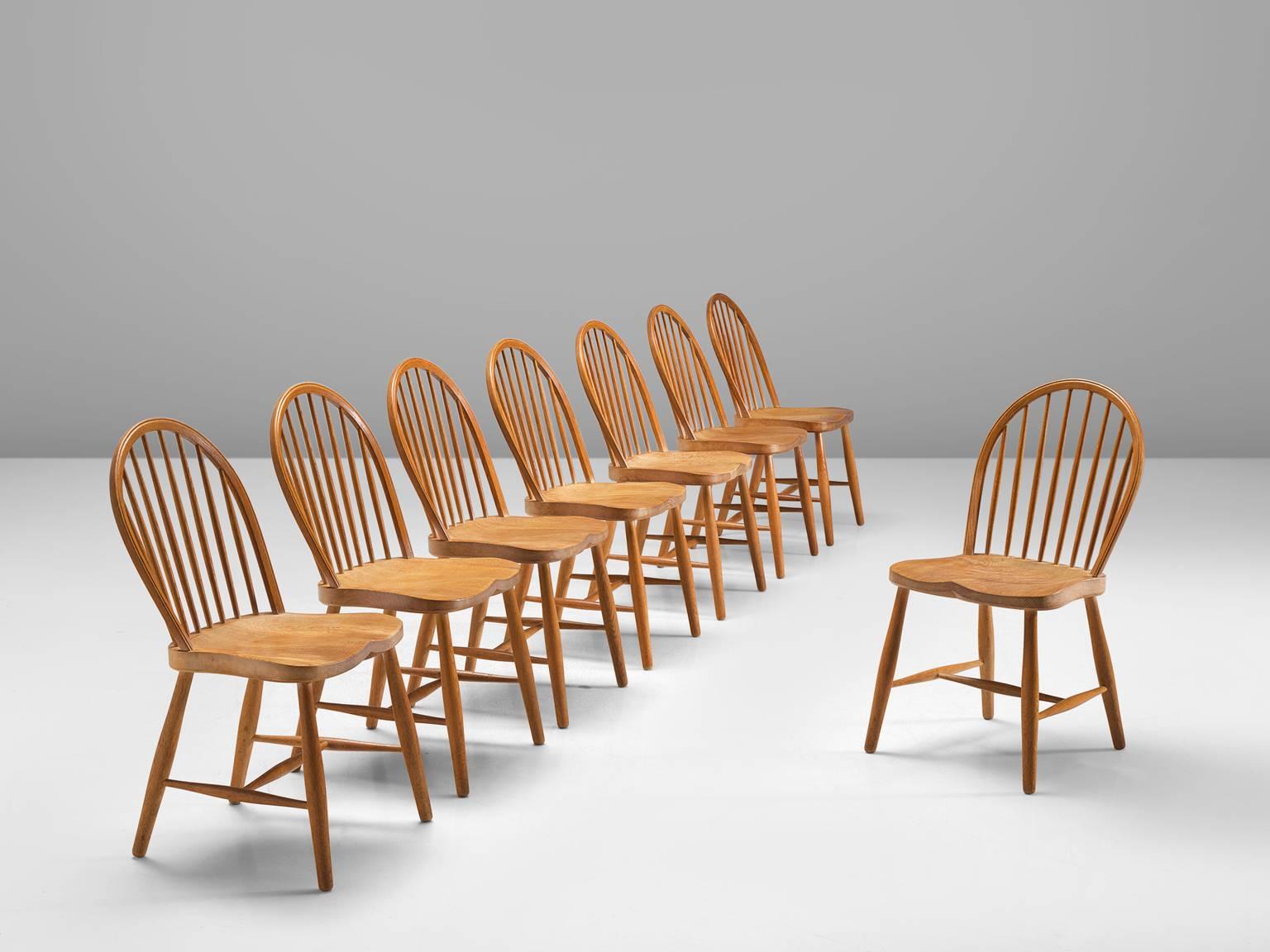 Frits Henningsen, set of eight chairs, oak, Denmark, 1940s

These modern Windsor type chairs were designed and made by Frits Henningsen. They are part of the midcentury design collection. The back provides an open look thanks to the spindles. The