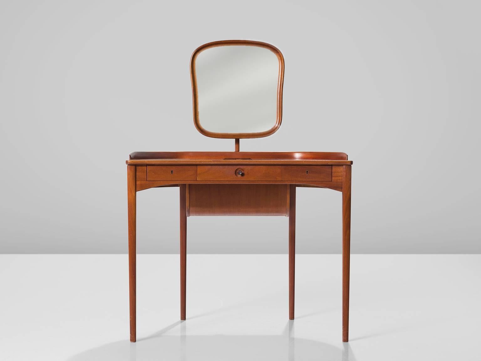 Vanity table in teak with mirror, Italy, 1950s.

This small vanity table with organic mirror is supported by a delicate table with four cylindrical legs. The table has a drawer in the middle and the back legs are placed closer together than the