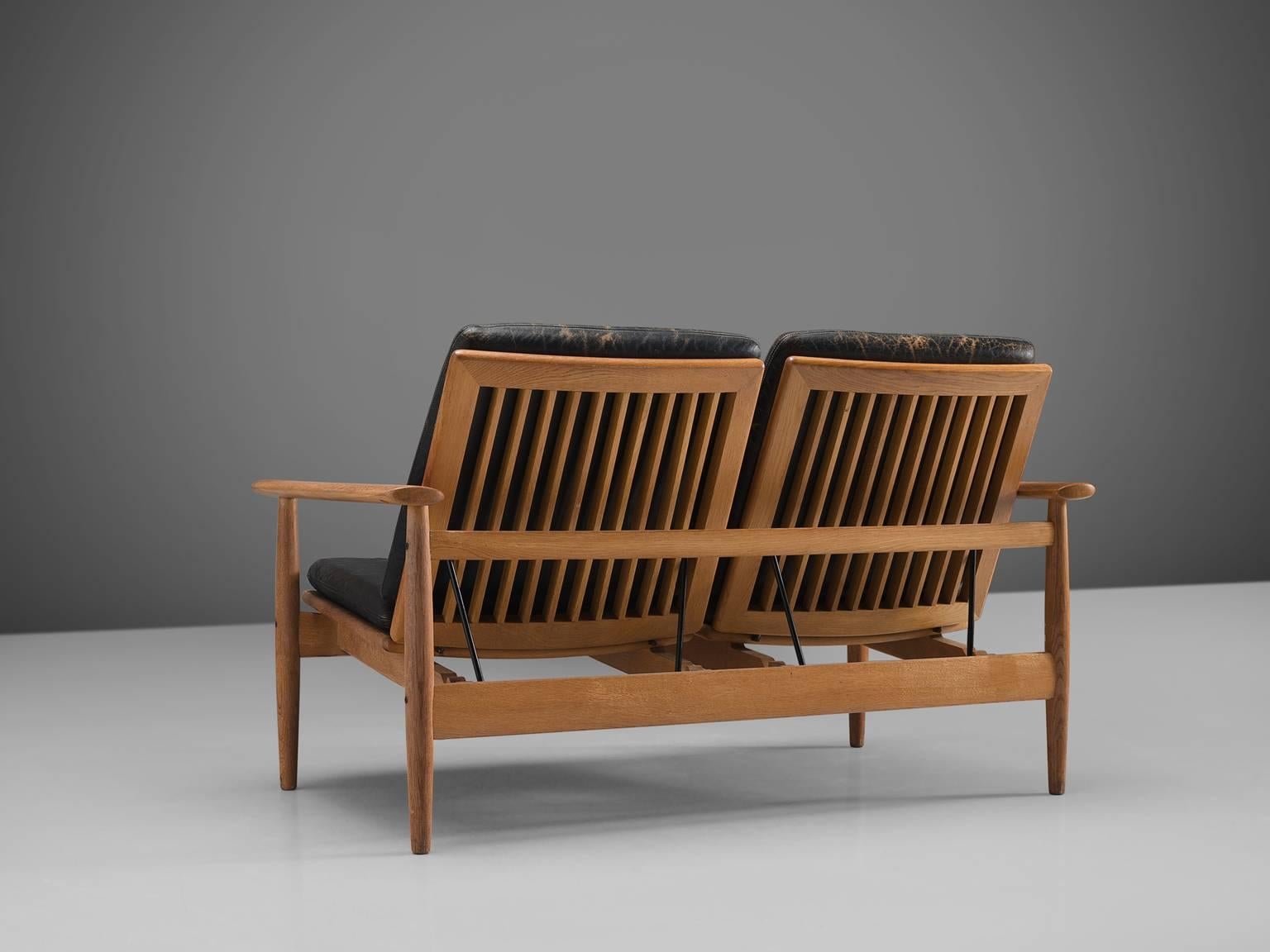 Johan Hagen, sofa, oak, black leather, Denmark, 1960s

This little sofa is executed in oak and upholstered with black leather. One of the main features of this modest piece is its slatted back. The back is adjustable and can therefore be put in any