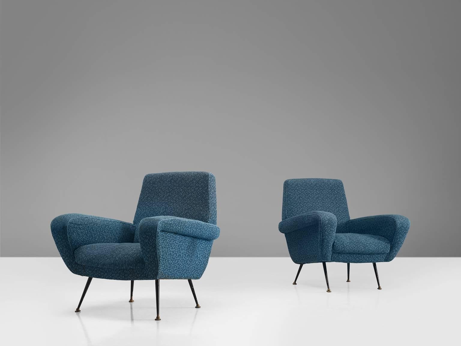 ISA armchairs, blue fabric (re-upholstery needed) wood, and brass, Italy, 1950s.

This dynamic set of two armchairs features a high back, voluptuous armrests and extremely slender and delicate legs. The four tapered delicate legs give this sofa a