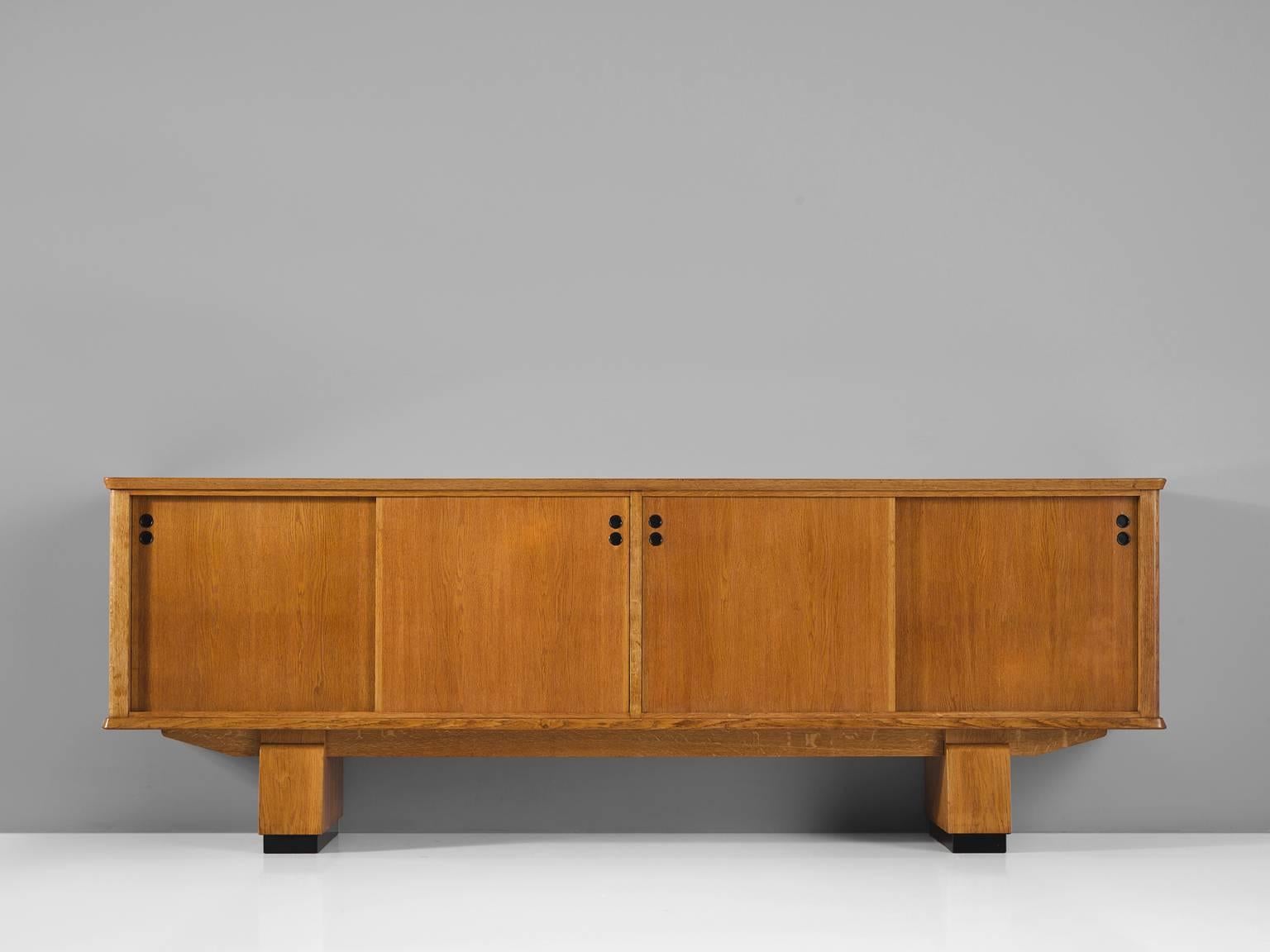Rene Gabriel, sideboard in oak and polyester, France, 1930s. 

This French Art Deco style cabinet is executed in oak and the detailing is executed in lucite which has been recently been renewed. This sturdy legged sideboard with features two thick