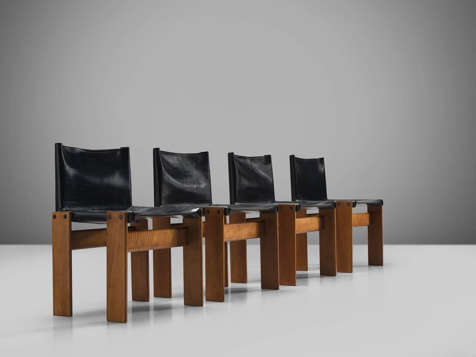 Dining chairs by Afra & Tobia Scarpa, beech and black leather, Italy, 1974.

TThe wonderfully deep black leather forms a striking combination with the blond oak. Interesting is the 'flat' shape of this chair where the designer has chosen to place