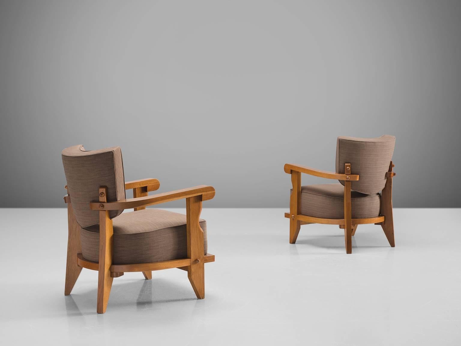 Jacques Chambron and Robert Guillerme, set of two easy chairs, grey fabric, oak, France, 1950s

This sculptural set of easy chairs by Guillerme and Chambron is very well executed and made out of solid, carved blond oak. This set of comfortable