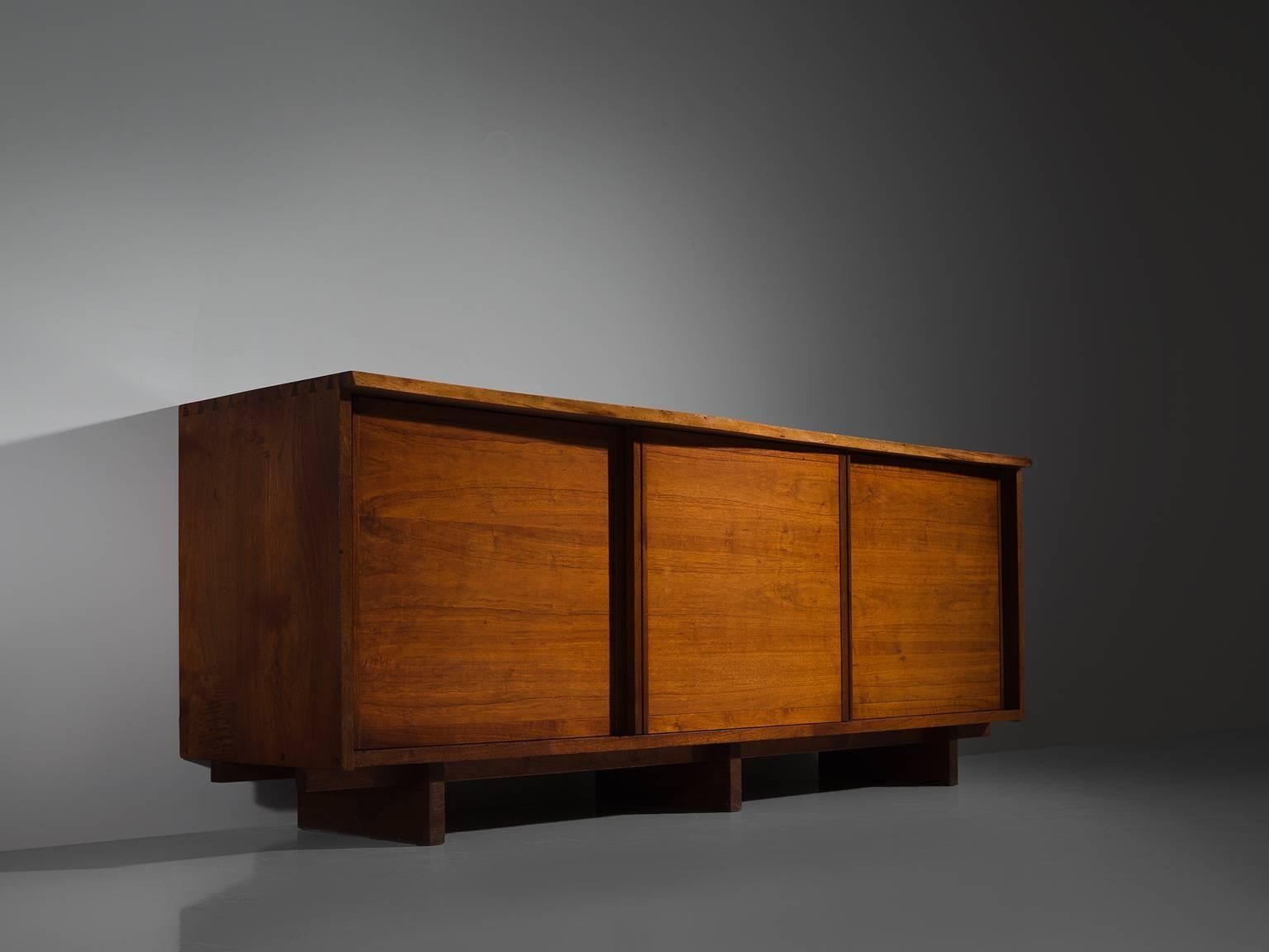 George Nakashima, triple sliding door cabinet, walnut, New Hope, PA, 1960s

Cabinet with three sliding doors and four drawers behind each door, executed in walnut with traditional and archetypical dovetail Nakashima wood-joints. The credenza is part