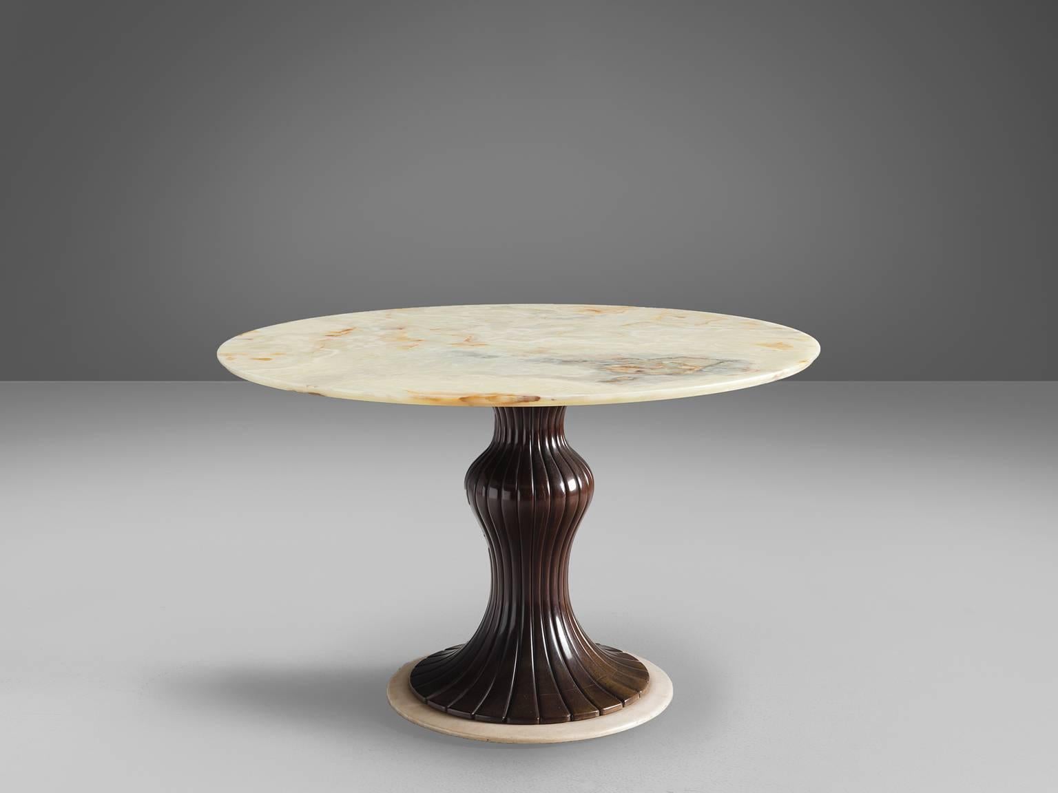 Osvaldo Borsani, dining table, marble, mahogany, Italy, 1950s. 

This distinctive center table is made in the 1950s and holds a wooden decorated shaft. The main feature of this table is the almost translucent white marble top. The yellow and grey