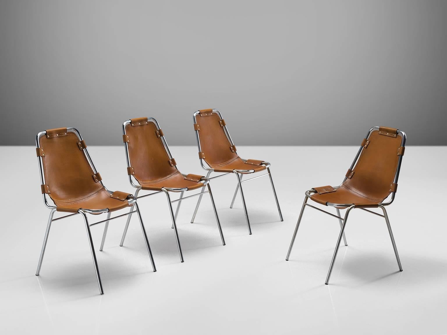 Set of four chairs 'les arcs', in steel and cognac leather, France, circa 1970s. 

Set of four chairs of the famous model 'Les Arcs.' The simplistic design consists of a tubular steel frame with a seating of thick cognac saddle leather. The natura