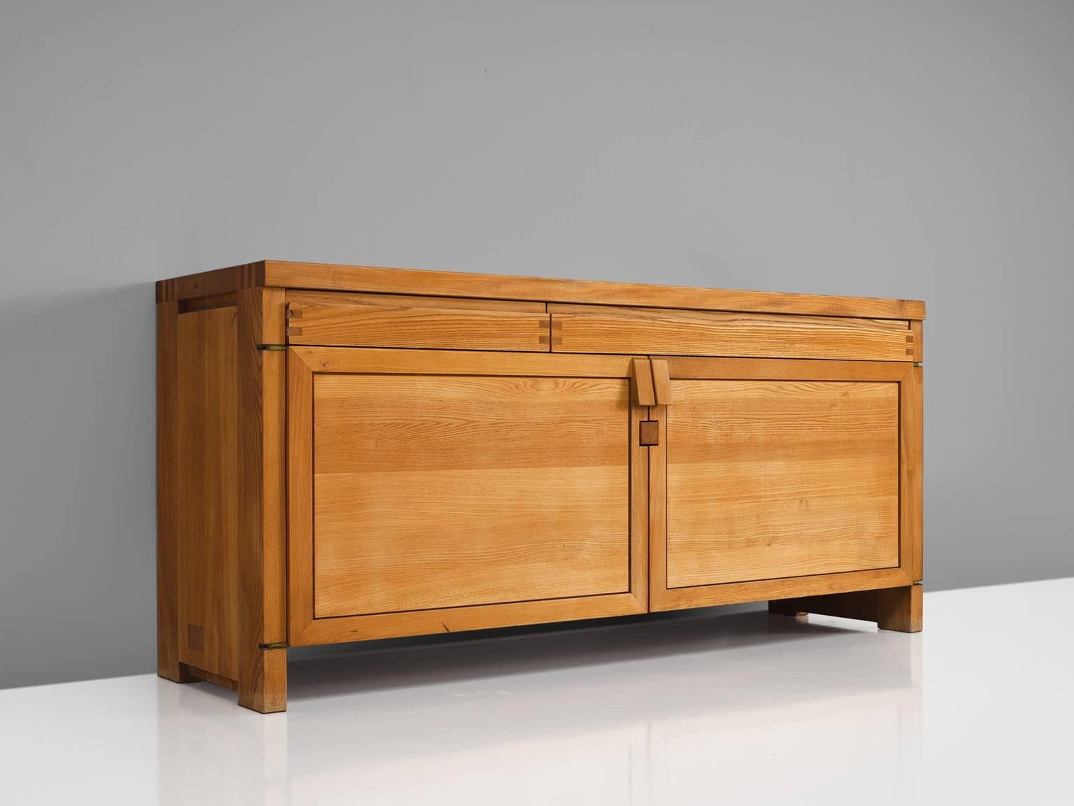 Pierre Chapo, sideboard, two-door long sideboard model R08, elm, France, 1964.

This exquisitely crafted credenza combines a simplified yet complex design combined with nifty, solid construction details that characterize Chapo's work. The well