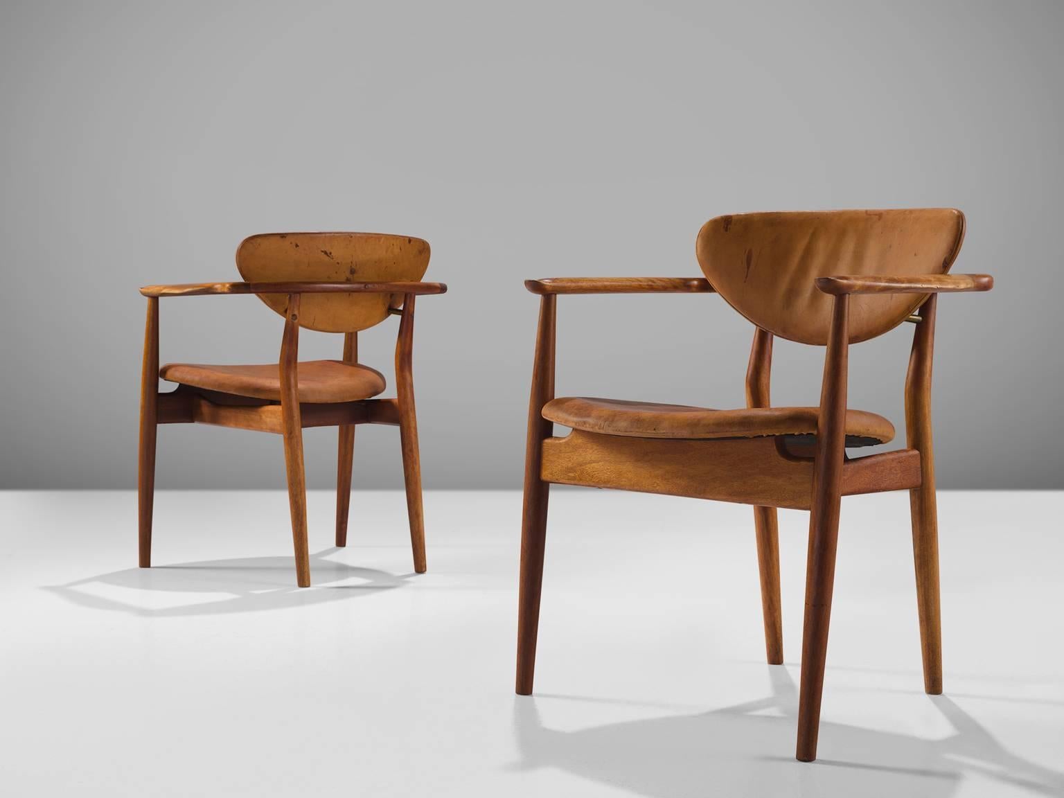 Finn Juhl for Niels Vodder, 'FJ 55', mahogany and leather, Denmark, 1950s.

This set of mahogany armchairs is made by Finn Juhl and executed by Niels Vodder. The chairs are quintessentially by Juhl and feature cognac leather seat and back that is