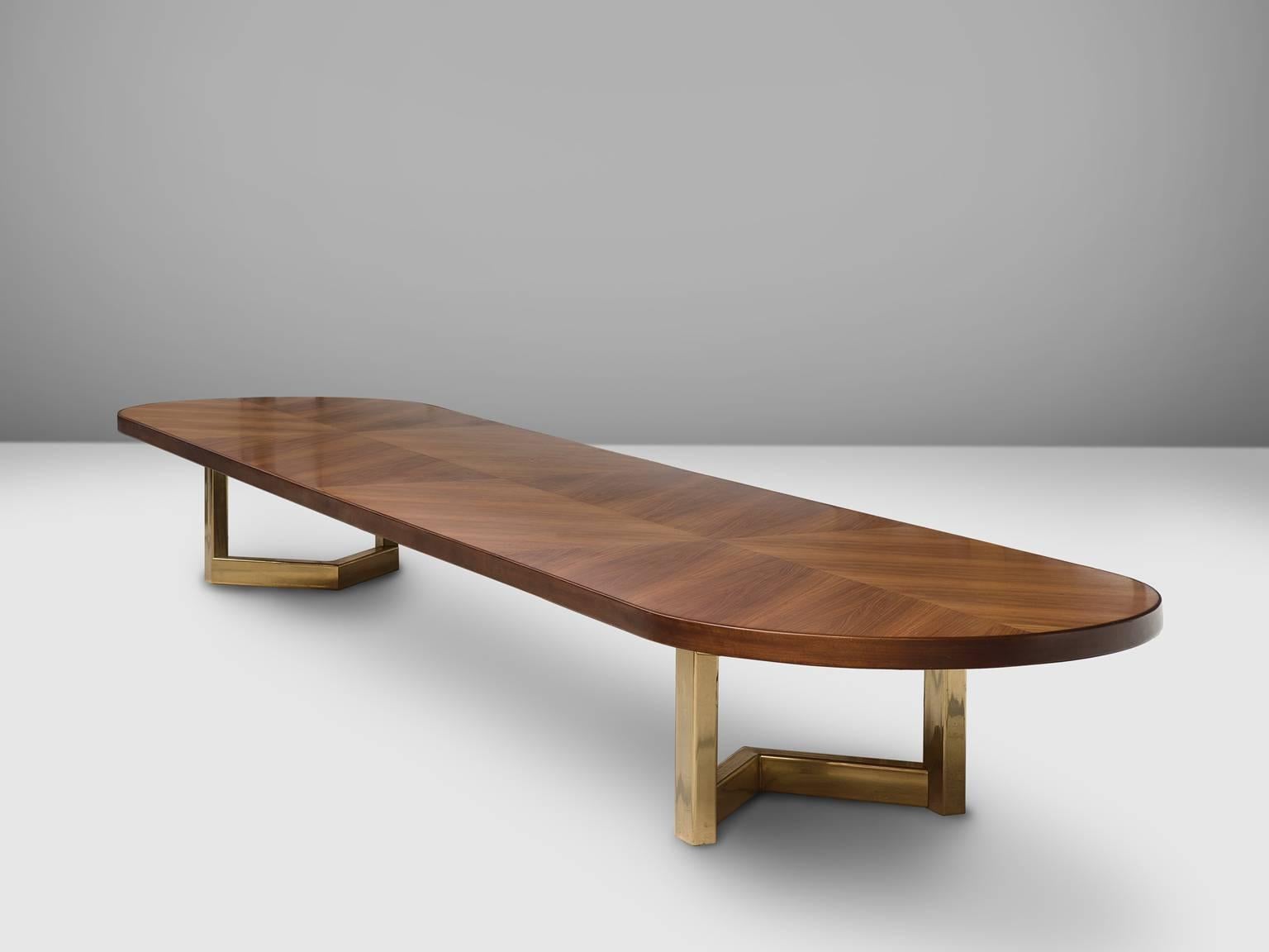 Dining table, in rosewood and brass, France, 1970s. 
 
The most important facet of this large table is the fact that the topic is executed from one piece. Furthermore, this large conference table features a sculptural brass base. The table is