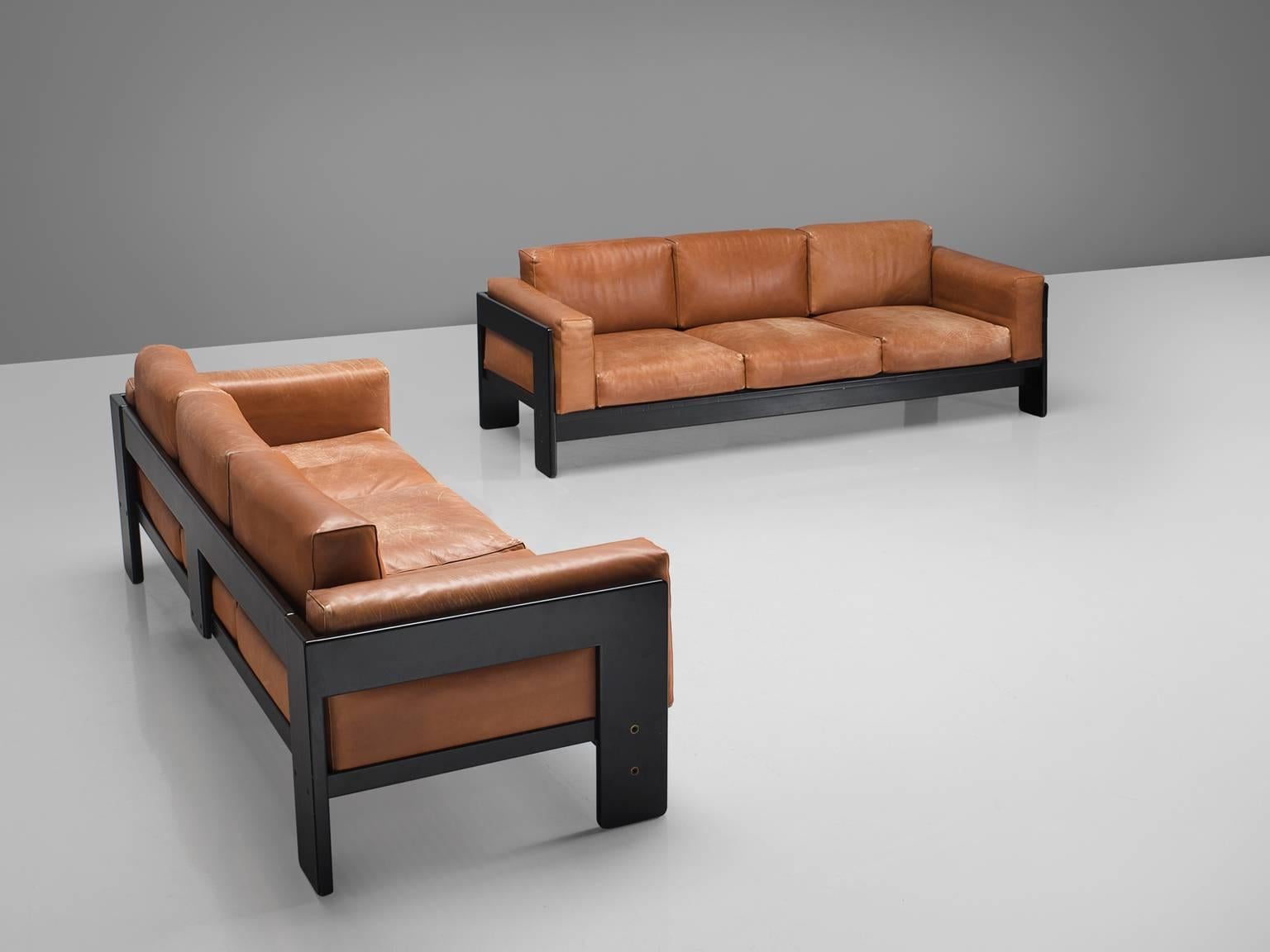 Tobia Scarpa for Knoll, 'Bastiano' sofas, leather, wood, Italy, design 1962, 1990 production.

This pair of Bastiano sofas is designed by Tobia Scarpa in 1962. The three-seat features thick brick red leather and a stained dark wooden basket frame.