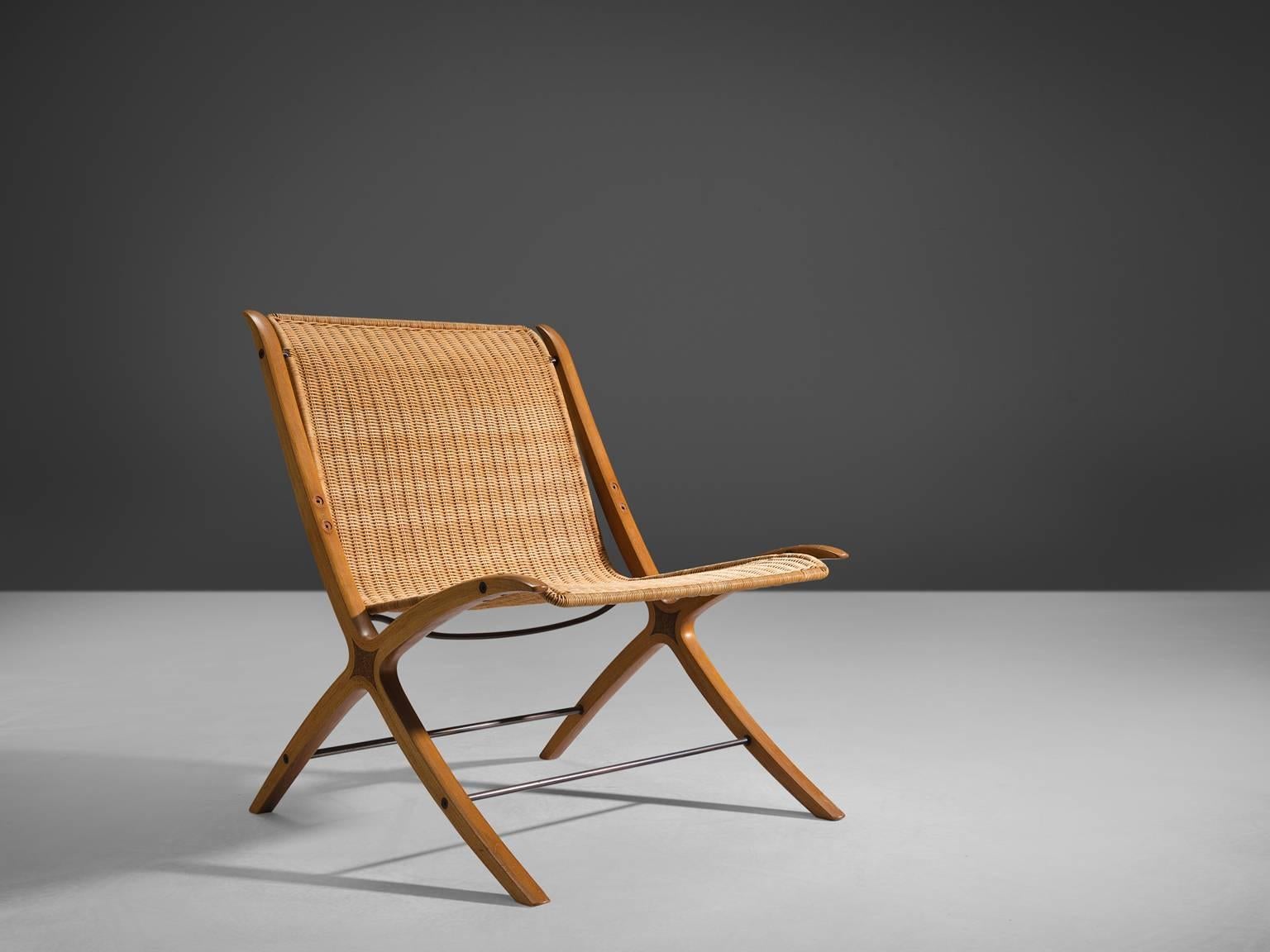 Peter Hvidt &Orla Mølgaard Nielsen for Fritz Hansen, X-chair 'model 6103', in cane, maple and mahogany, Denmark, 1958.

This chair is for obvious reasons nicknamed the X-chair. The detailing of this X-design runs all the way from the front legs to