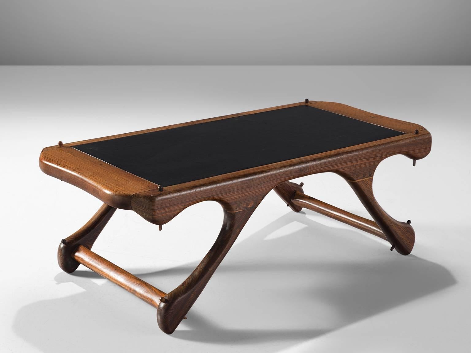 Don S. Shoemaker for Señal Furniture, coffee table, in cocobolo and black leather, Mexico, 1960s. 

This sculptural coffee table in Cocobolo rosewood and leather are made in Mexico. The table is accompanied by a set of chairs that is also part of