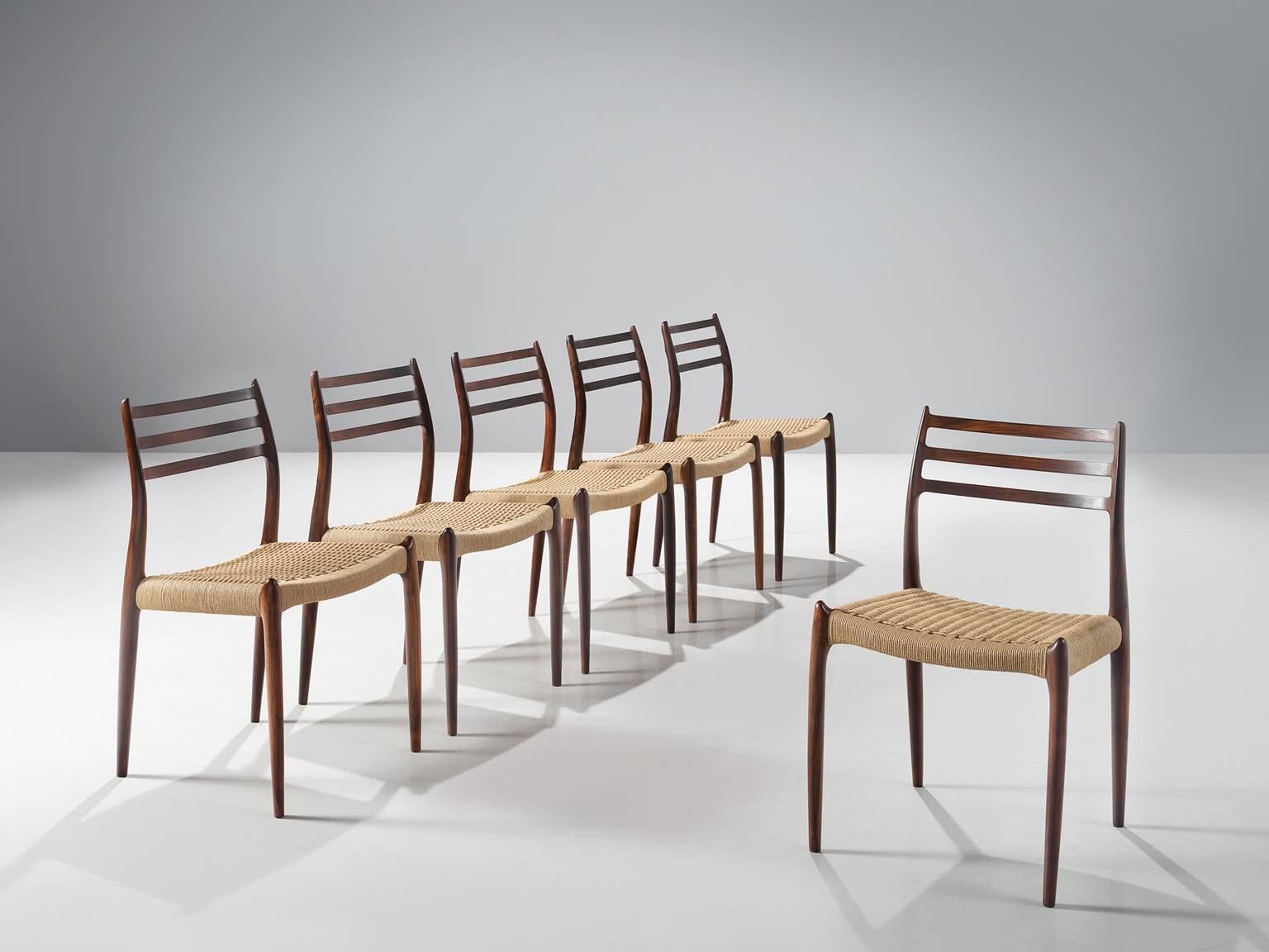 Niels Otto Möller for J.L. Møllers Møbelfabrik, set of six dining chairs model 85, rosewood and wickered cane, Denmark, 1960s.

These iconic dining chairs by Möller are upholstered with cane by our upholstery studio. The design of model 85 is one