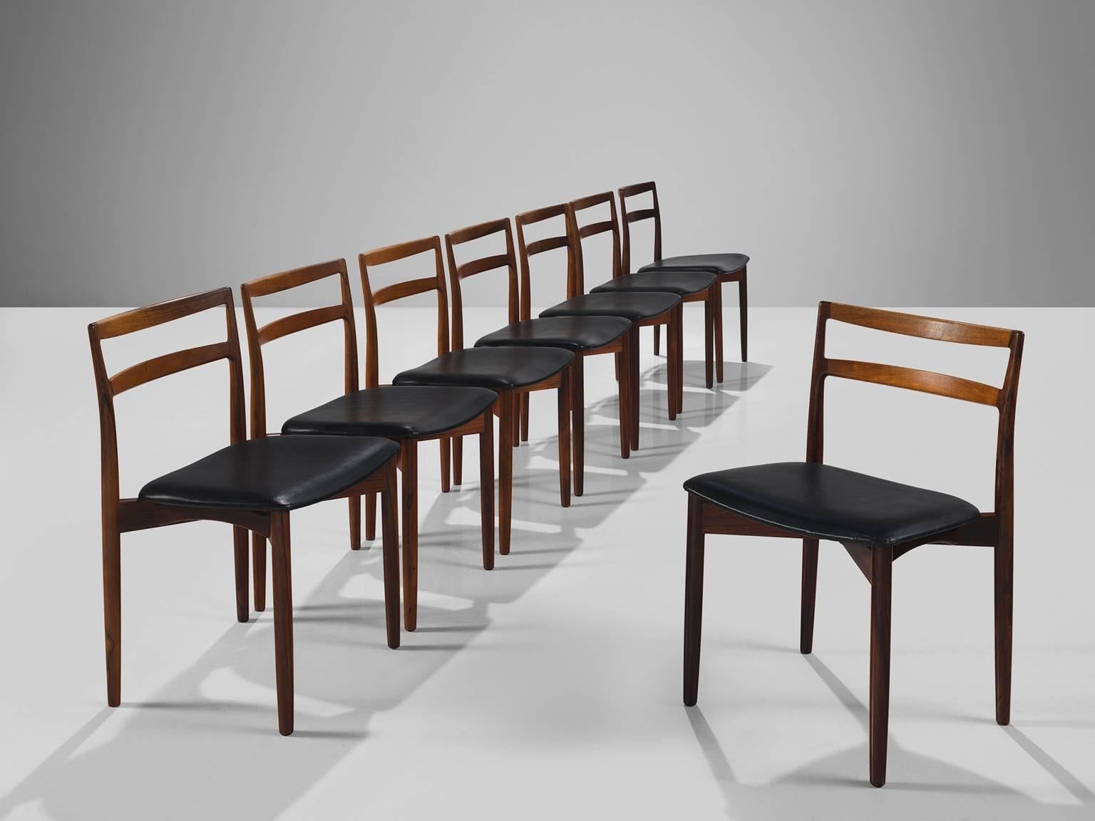 Harry Østergaard for Randers Møbelfabrik, set of eight rosewood chairs with black leatherette model 61, Denmark, 1960s.

Set of eight dining chairs in rosewood with black faux leather upholstery. The basic and linear character of the wooden frame