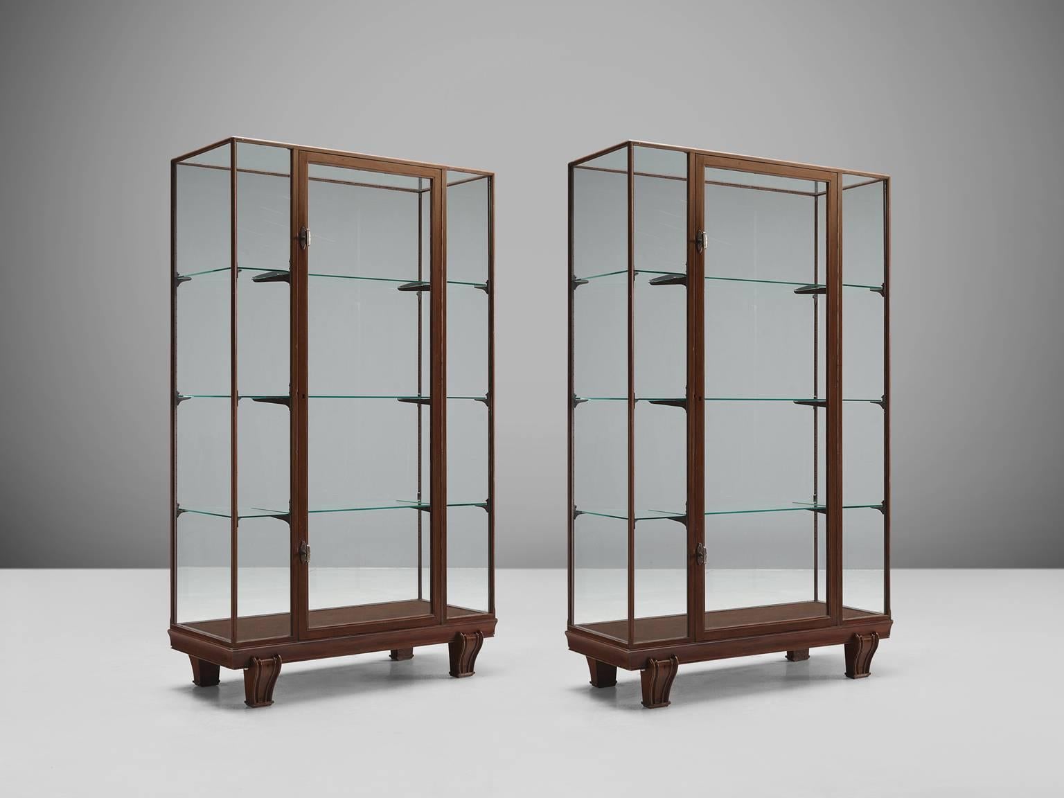 Pair of vitrines, wood, glass, steel, Europe, 1960s.

Sturdy and Minimalist showcases in glass and wood. The base of this vitrine is beautifully simply designed as it features a wooden foot that is built up of four sturdy feet. The middle panel