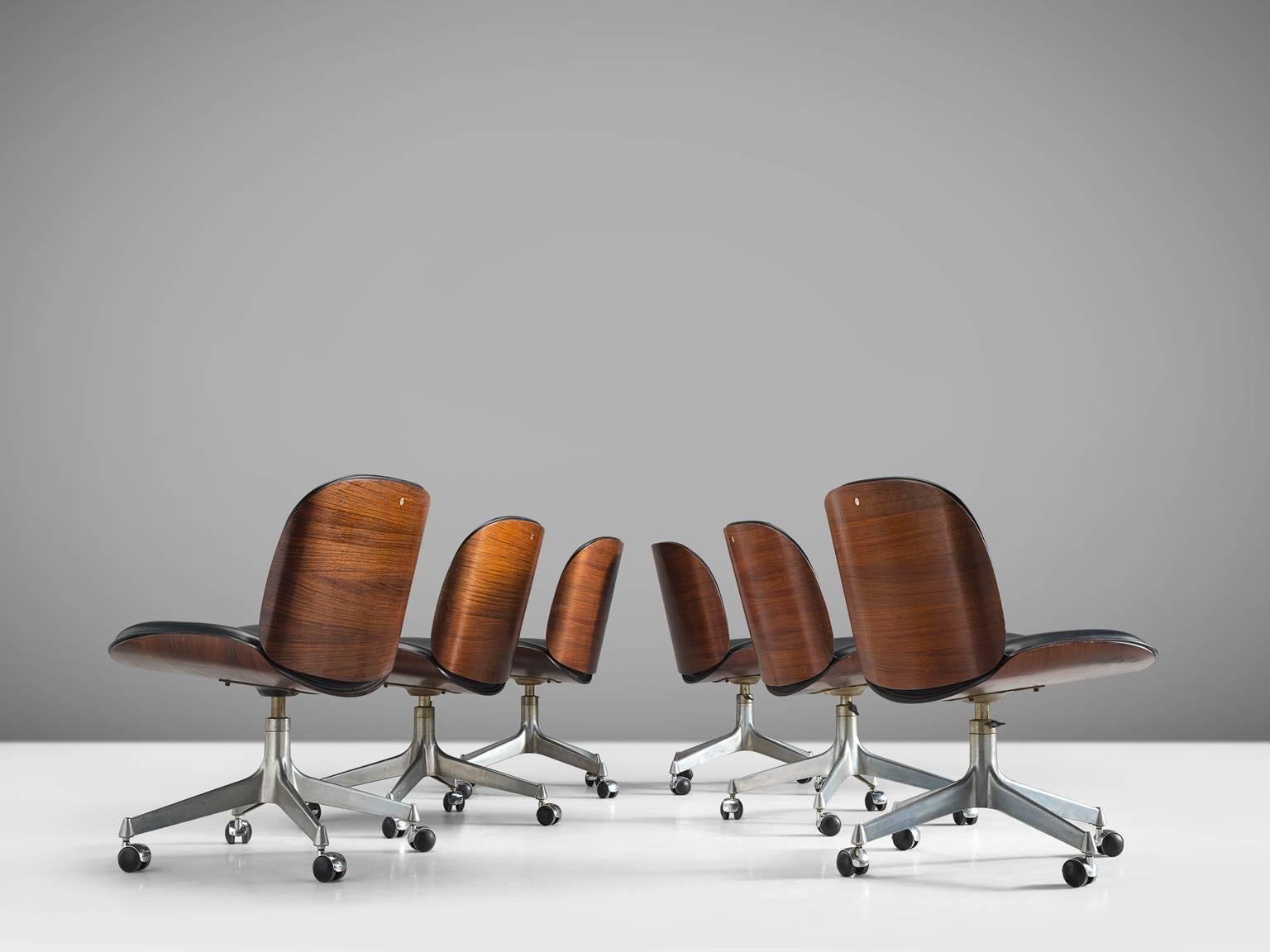 MIM Roma, set of six desk chairs, rosewood, metal, black faux leather, Italy, 1950s.

Set of six swivel office chairs from the 'Terni' series by MIM Roma. Seating and back are slightly curved and both halves are mirrored creating a vibrant