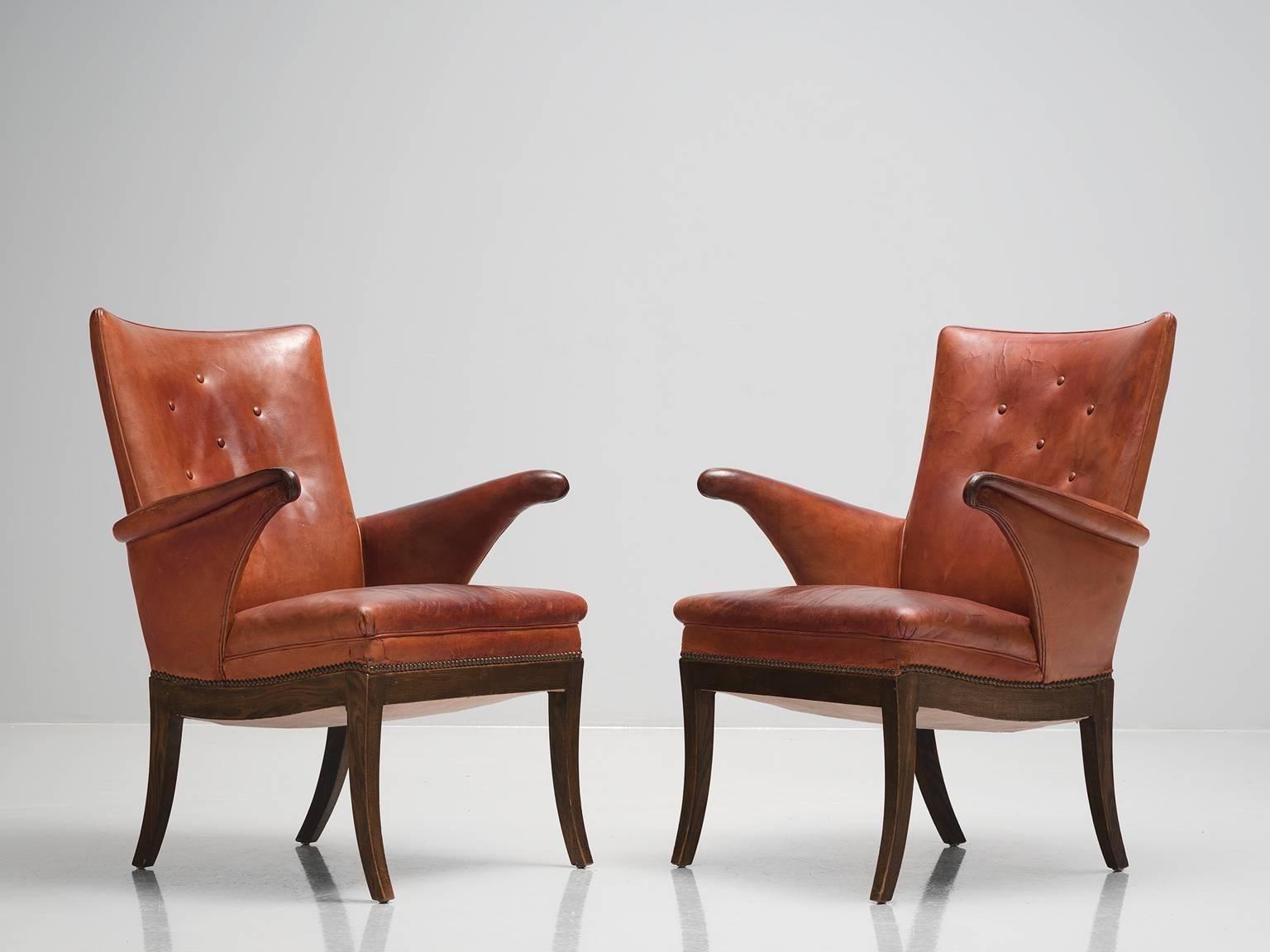 Frits Henningsen, pair of cognac leather armchairs in mahogany, Denmark, 1930s.

This pair of comfortable lounge chairs was designed and produced by master cabinet maker Frits Henningsen, circa 1930s. The balanced, rigid lines of the solid