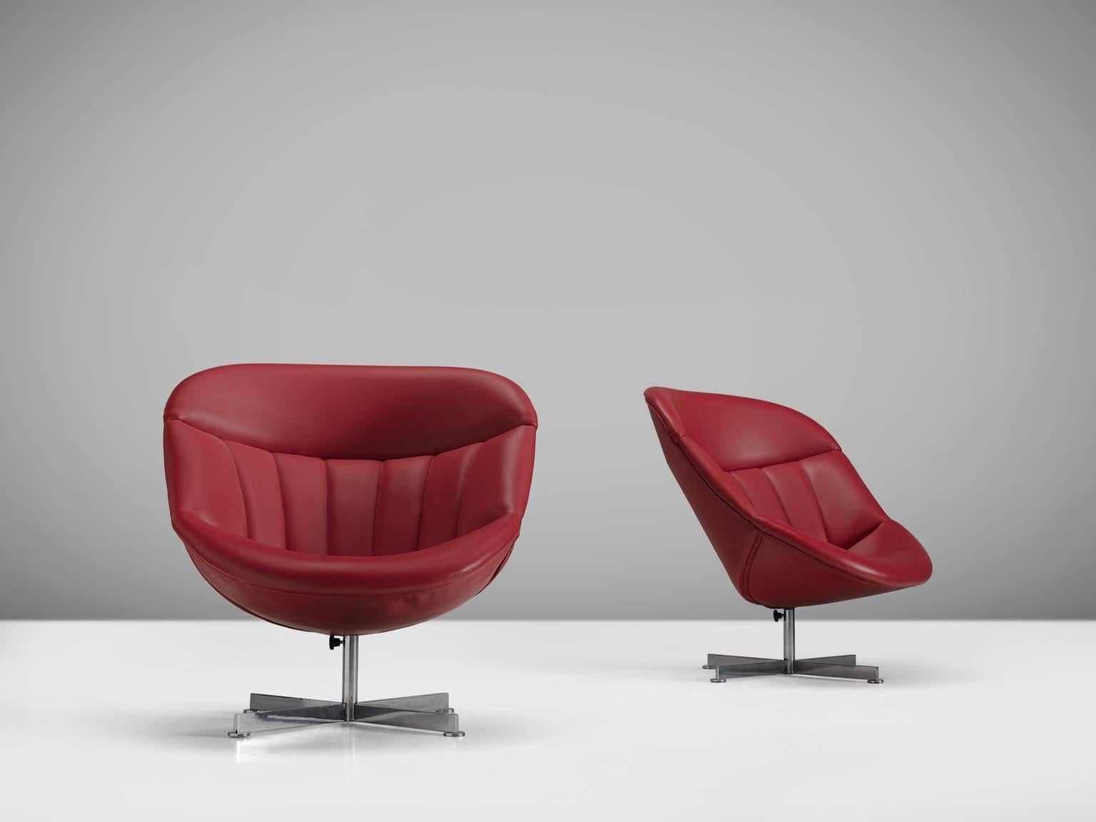 Rudolf Wolf for Rohe, lounge chairs, in metal and red faux-leather, the Netherlands, 1950s. 

These faux-leather red chairs are both comfortable and aesthetically pleasing. The set is equipped with a swivel base and the Ferrari red shell is padded.