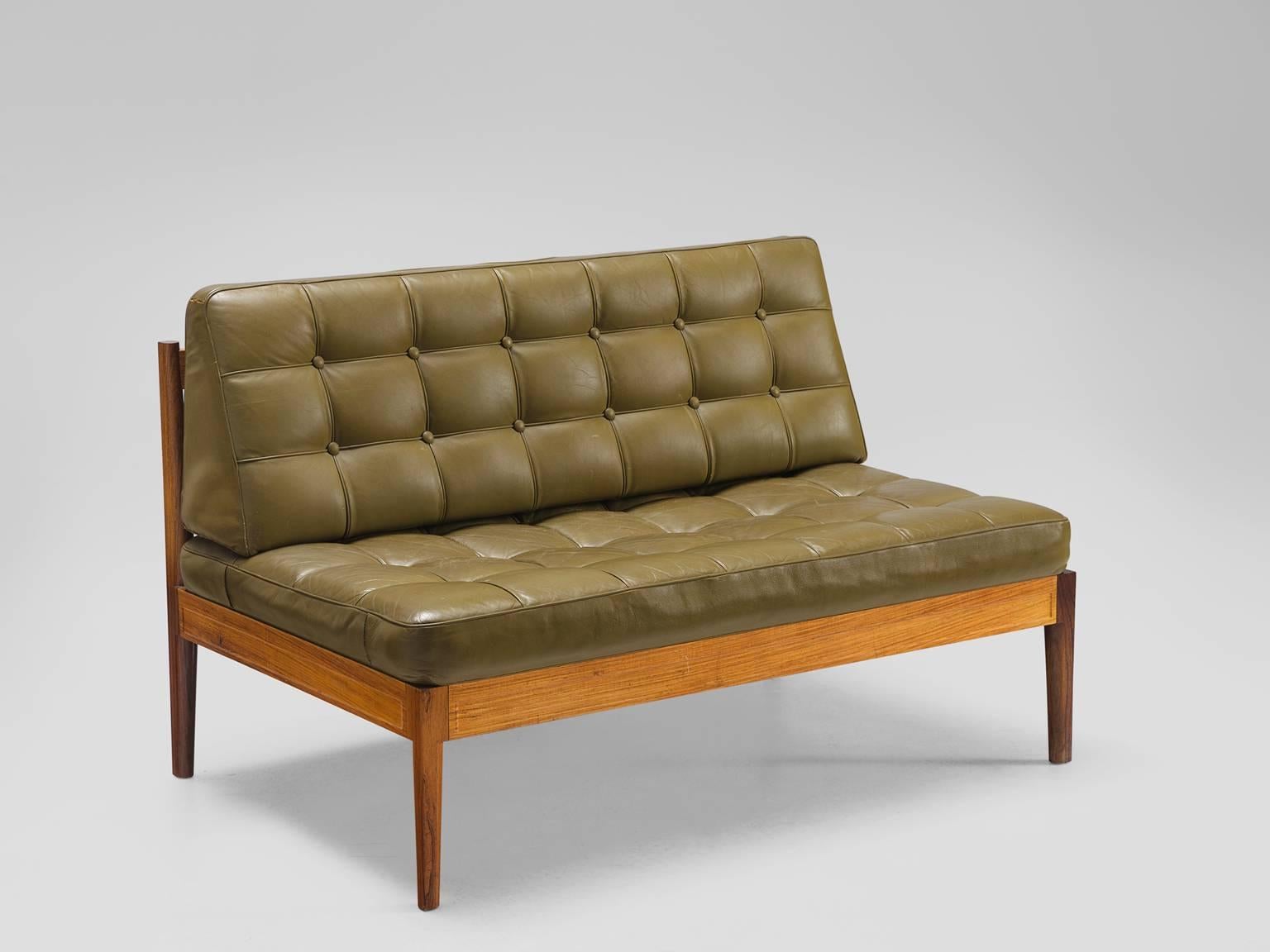 Finn Juhl for France & Søn, 'Diplomat', leather and rosewood, Denmark, 1960s

This small solemn rosewood bench is upholstered with an olive green tufted seat and back. The sofa is part of the 'Diplomat' series by the Dane Finn Juhl. The design