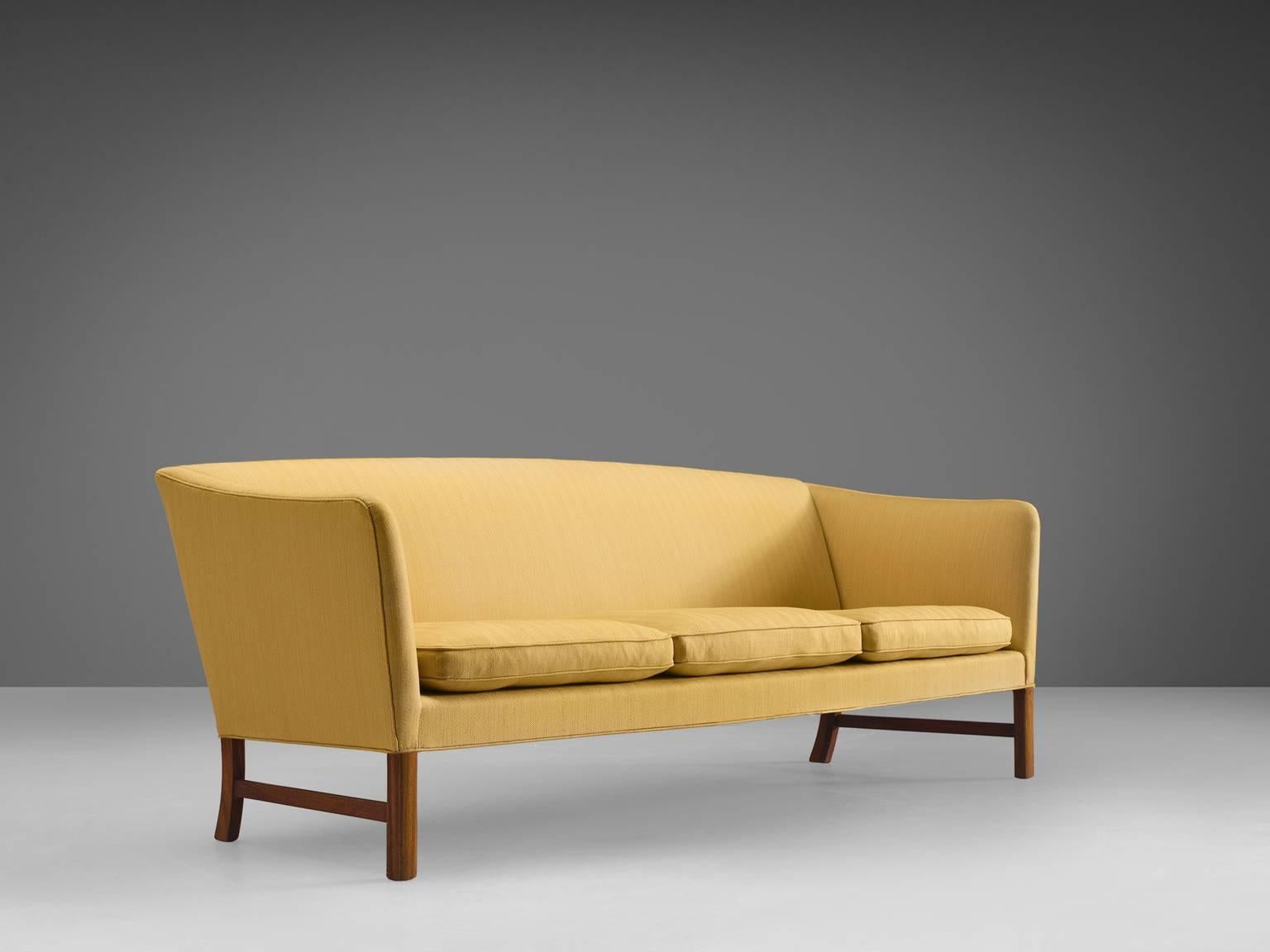 Ole Wanscher for A.J. Iversen, three-seat sofa in mahogany and yellow fabric, Denmark, 1950s. 

This sofa is designed by Ole Wanscher for A.J. Iversen. This sofa shows typical Danish design traits such as exquisite craftsmanship and modest