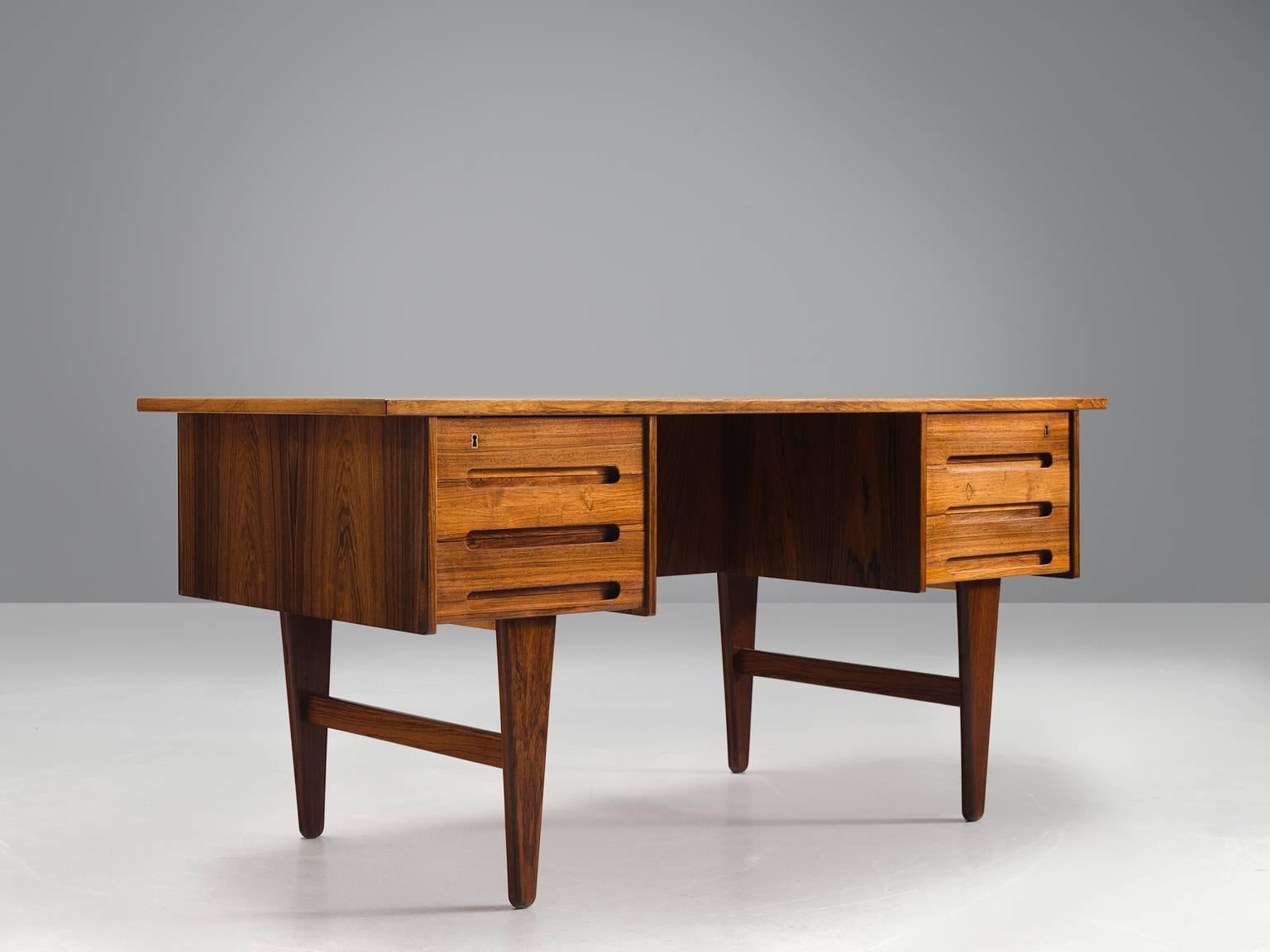 Kai Kristiansen, desk, rosewood and brass, Denmark, 1950s. 

This elegant, small desk is designed by is a Danish furniture designer Kai Kristiansen. The desk is executed in the finest rosewood and features two sections with a drawers on each side.