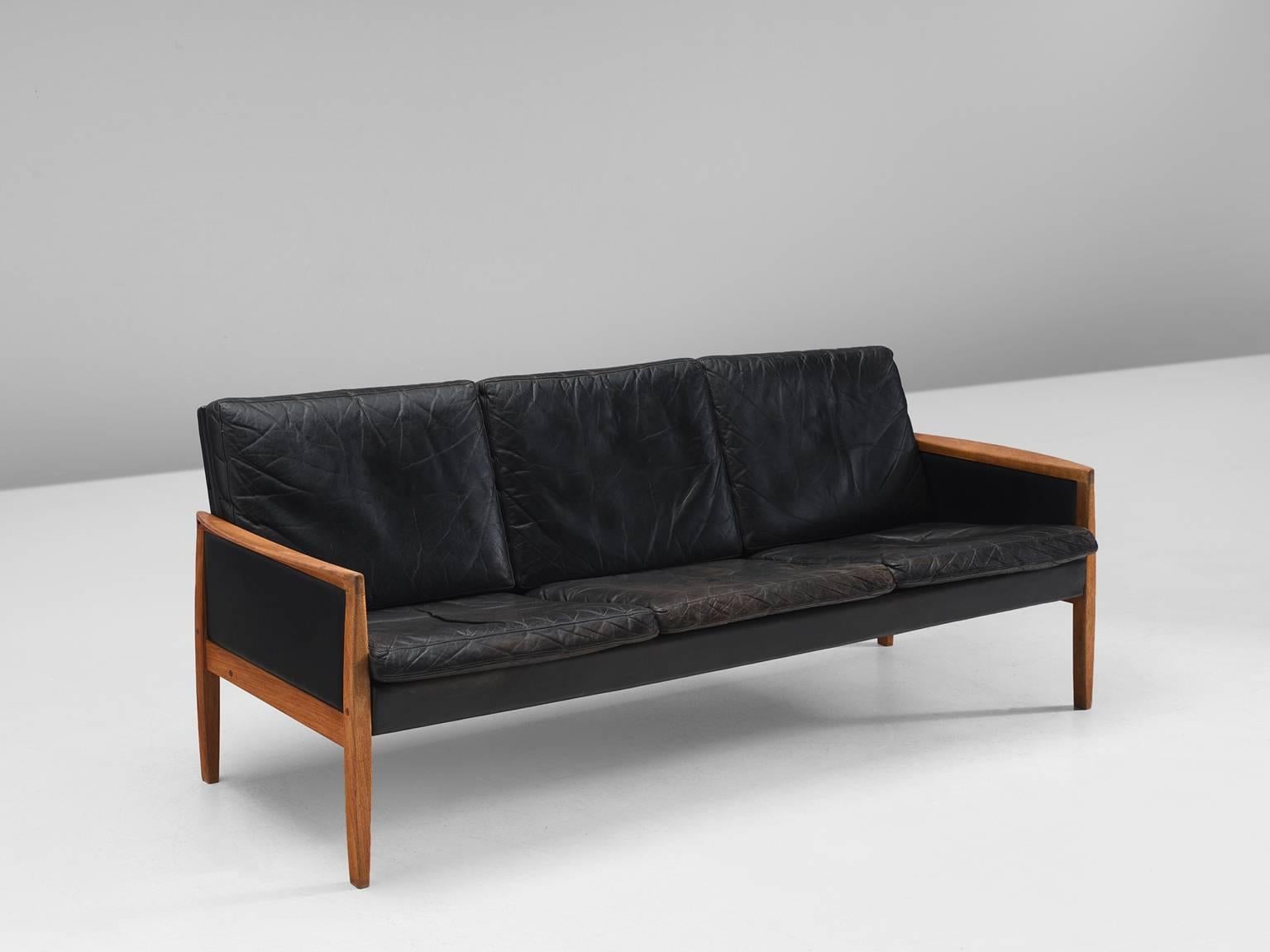 Hans Olsen for Brande, black leather and teak, Denmark, circa 1960

This leather three-seat sofa is designed by the Dane Hans Olsen for Brande. The sofa is executed in black leather that has patinated due to age. The sofa has a clean, modest