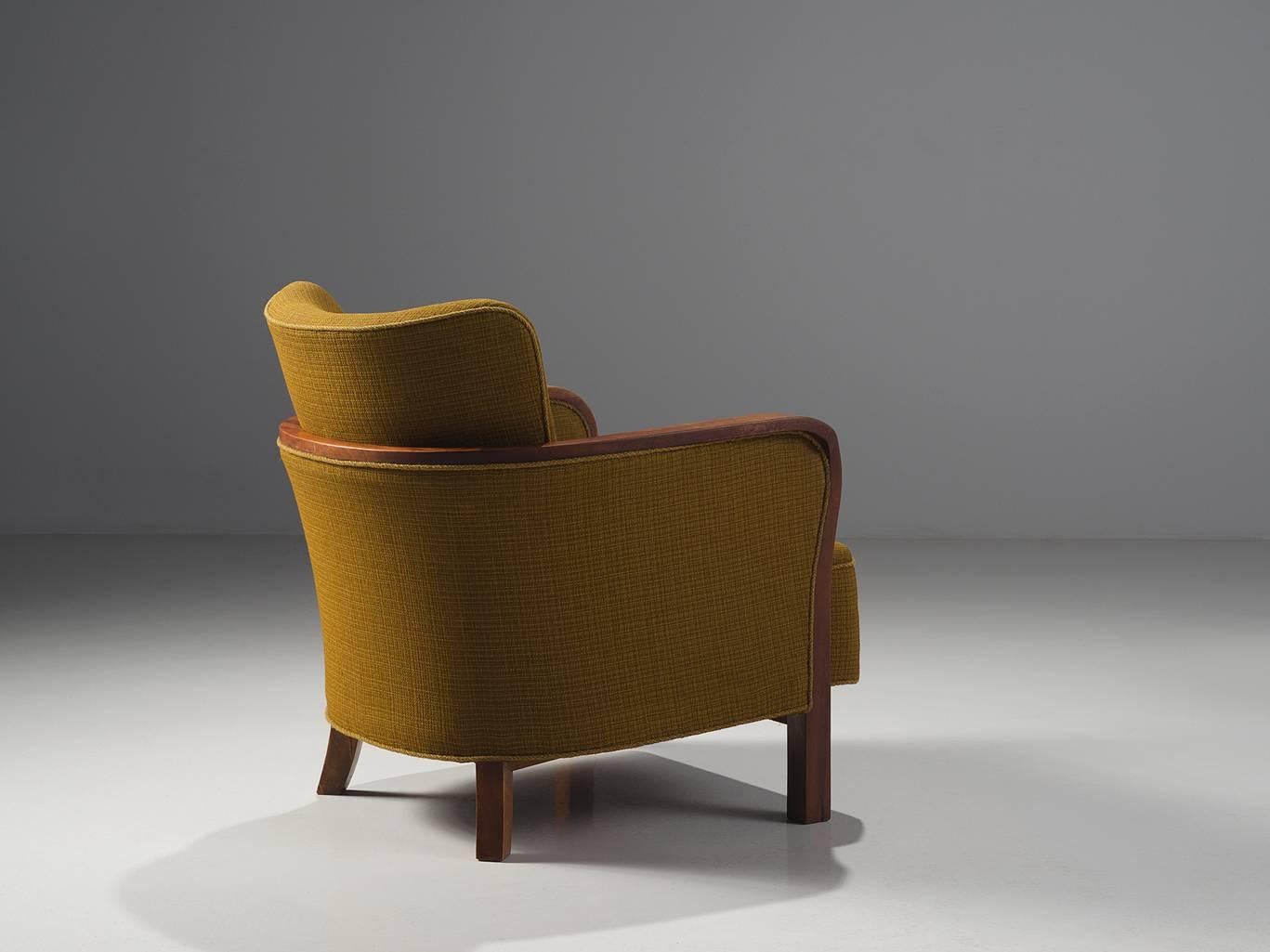 Easy chair, ocre fabric, stained beech legs, Denmark, 1940s. 

This Danish wingback chair is upholstered with the original ocre fabric that shows. The solid oak frame is sculptural and curved and flows organically into the armrests. The back is also