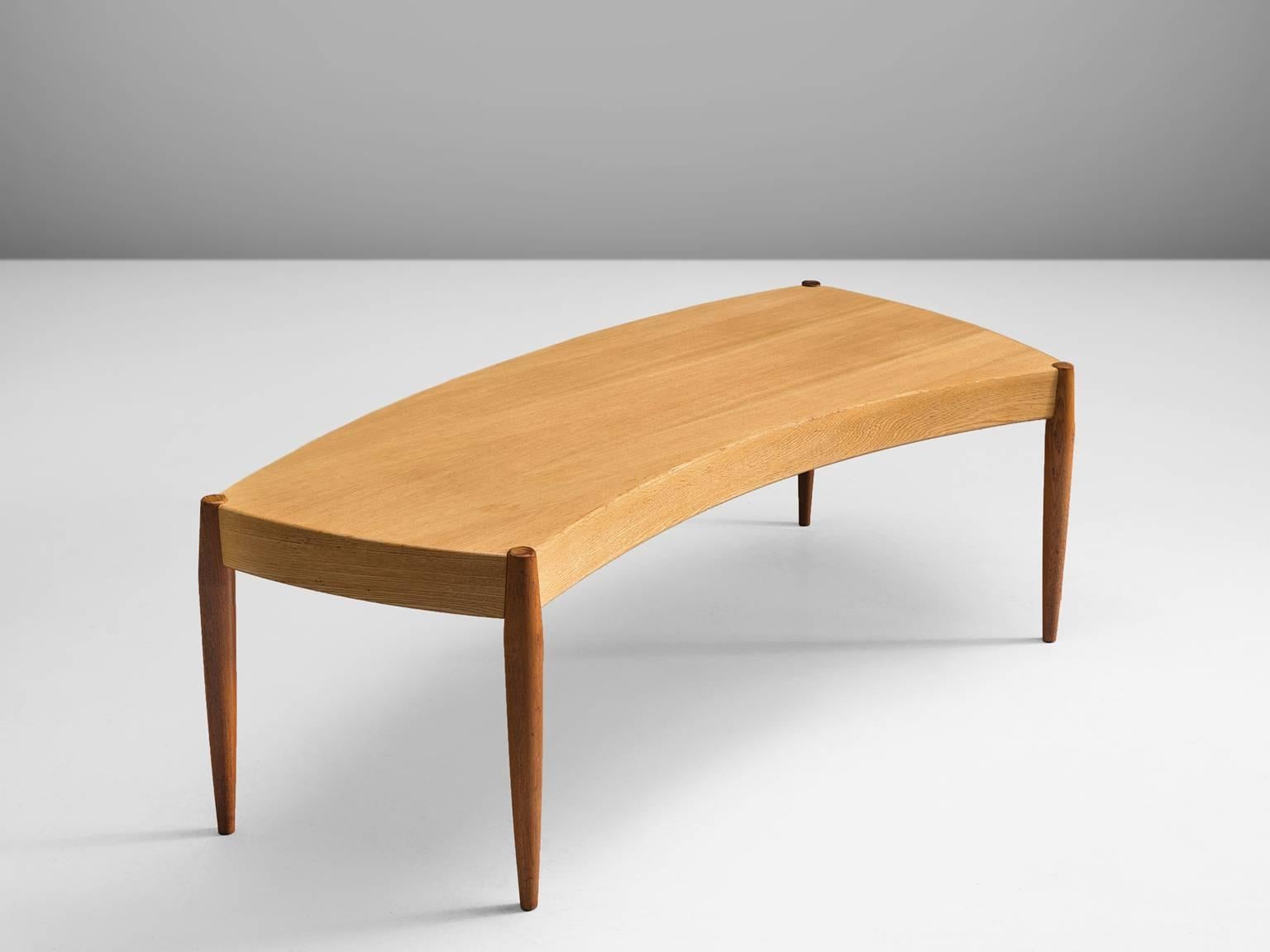 Side table, beech, teak, Scandinavia, 1950s

This bent table is executed with circular tapered teak legs and a curved blond wooden top. The contrast between the two types of colored wood in combination with the fluent shape of the table forms a