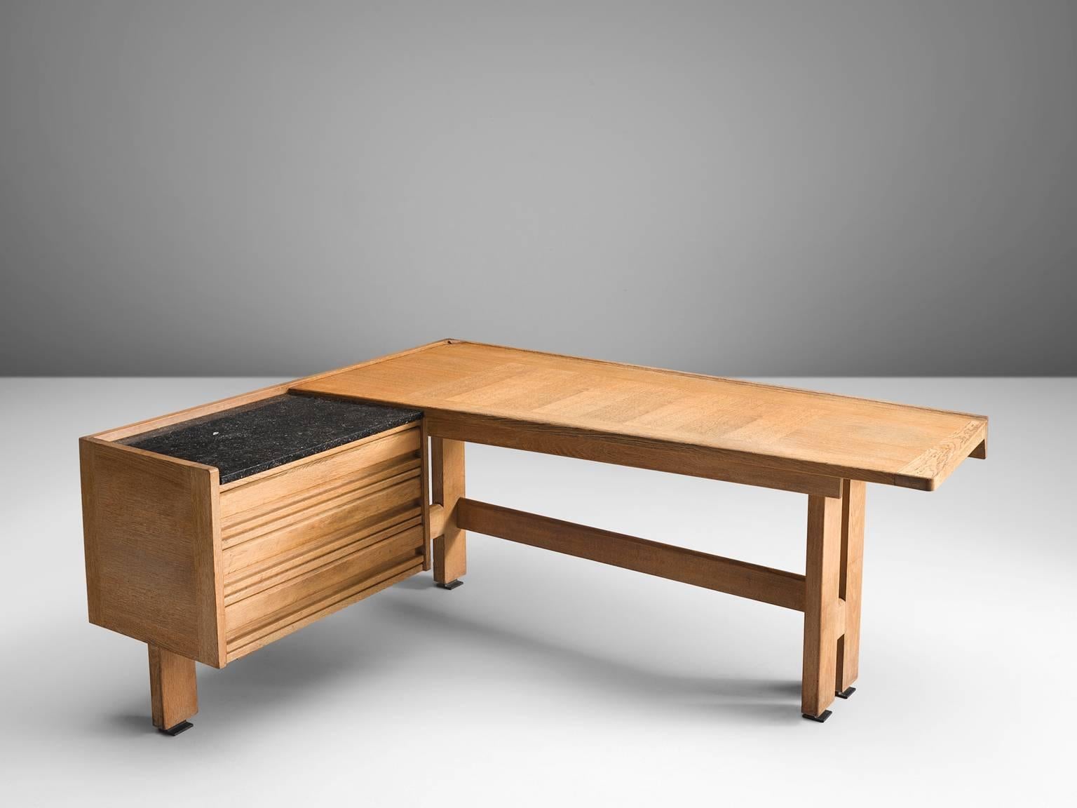 Guillerme et Chambron, desk, oak and granite, by France, 1960s. 

Corner desk by French designer duo Guillerme and Chambron. This executive desk holds the characteristic decorations and lines of this designer duo. The top is inlaid with wood in