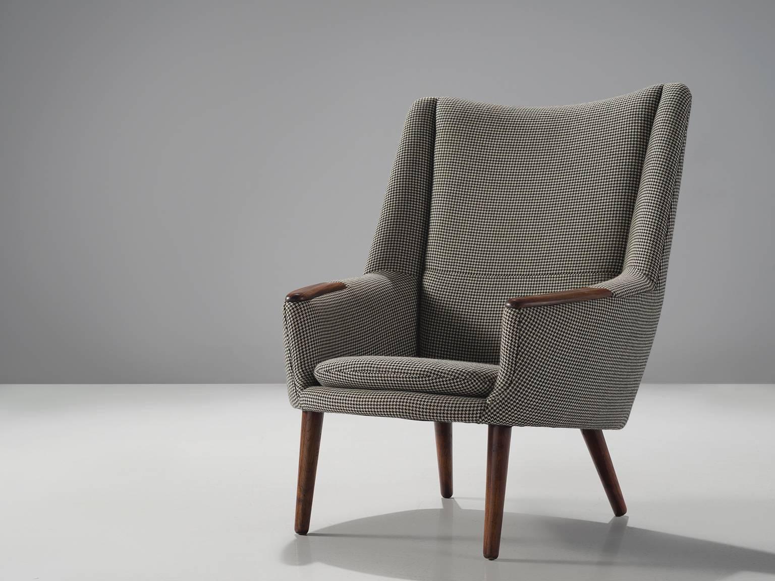 Kurt Østervig for Rolschau Møbler, armchair, fabric, rosewood, Denmark, 1958.

This armchair shows exquisite Danish craftsmanship and aesthetics. The high back chair features a slightly tilted back and comfortable cushions in both the seat and