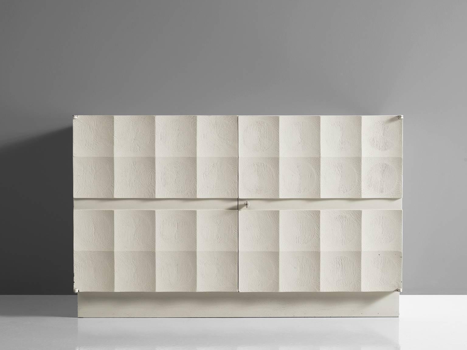 De Coene, sideboard, white oak, European, 1970s. 

Small Brutalist credenza in oak with graphic designed door panels. Two doors, each with a three-dimensional pattern of white squares. Each square has an inward pyramid figure, which gives this