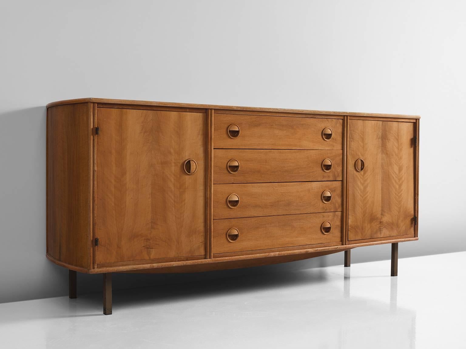 William Watting for Fristho, sideboard, teak and brass, 1960s. 

This cabinet by William Watting is executed with four high tapered brass legs which provides this piece with air and lightness. The sideboard is divided into three sections, the
