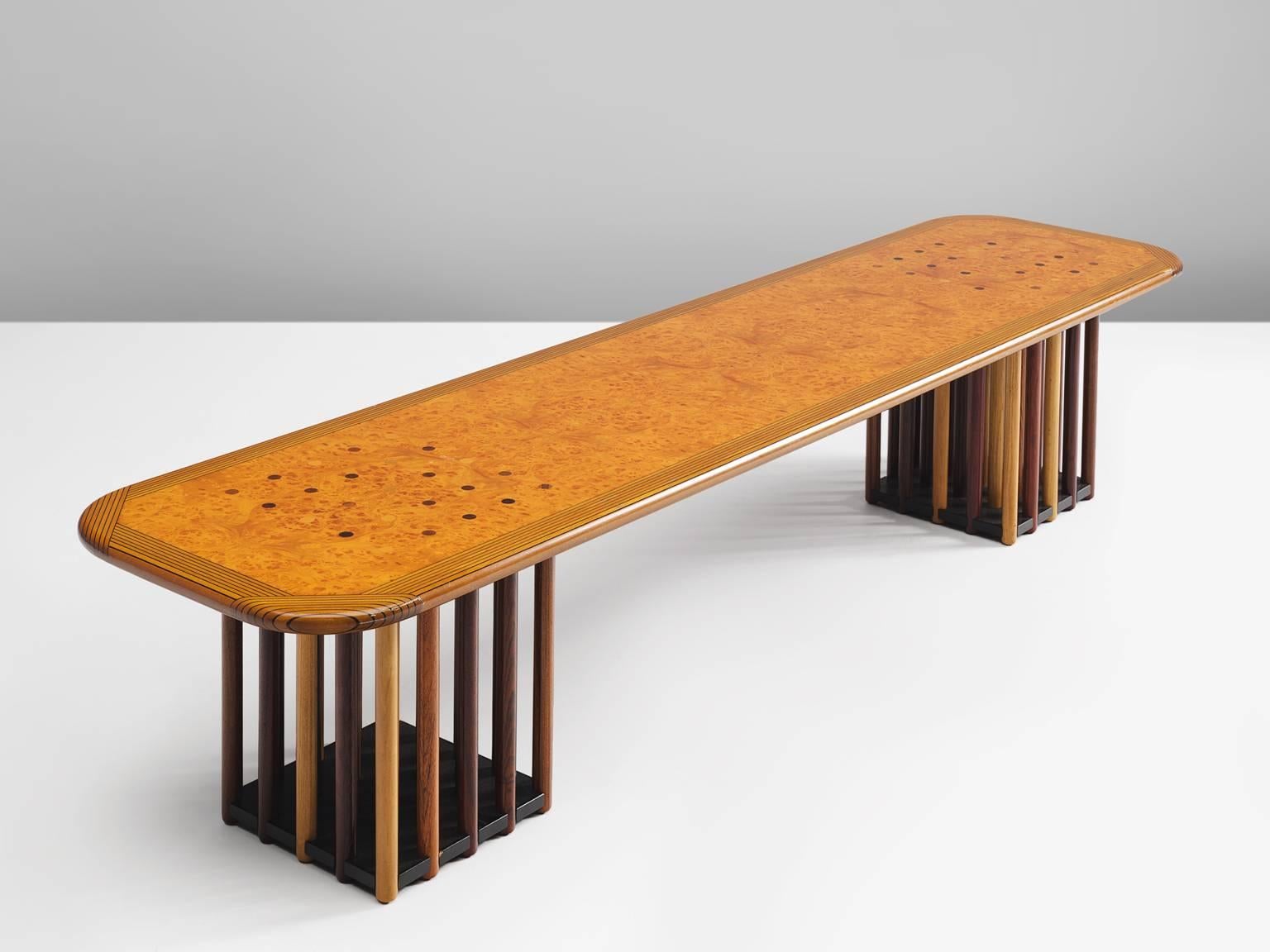 Afra Scarpa and Tobia Scarpa, coffee table, maple burl, birch, beech, oak, fruitwood, Italy, circa 1975

This extraordinary long table features two feet that exist of circular rods made out of different types of wood. The ends of the circular rods
