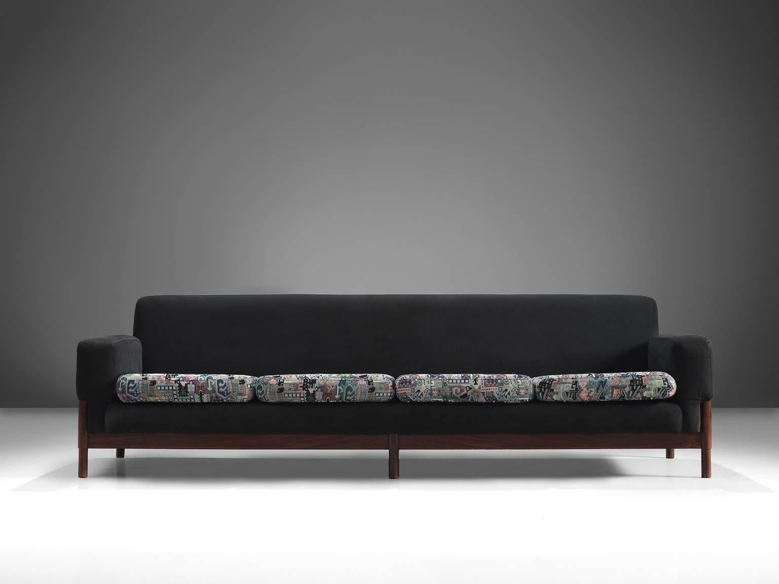 Four seat sofa, rosewood, fabric, Italy, circa 1950.

This elegant, geometric pair of sofa features a graphic pattern on the seat and a black fabric on the rest of the chair. The eloquent detail on these chairs is the slight curve on upper side of