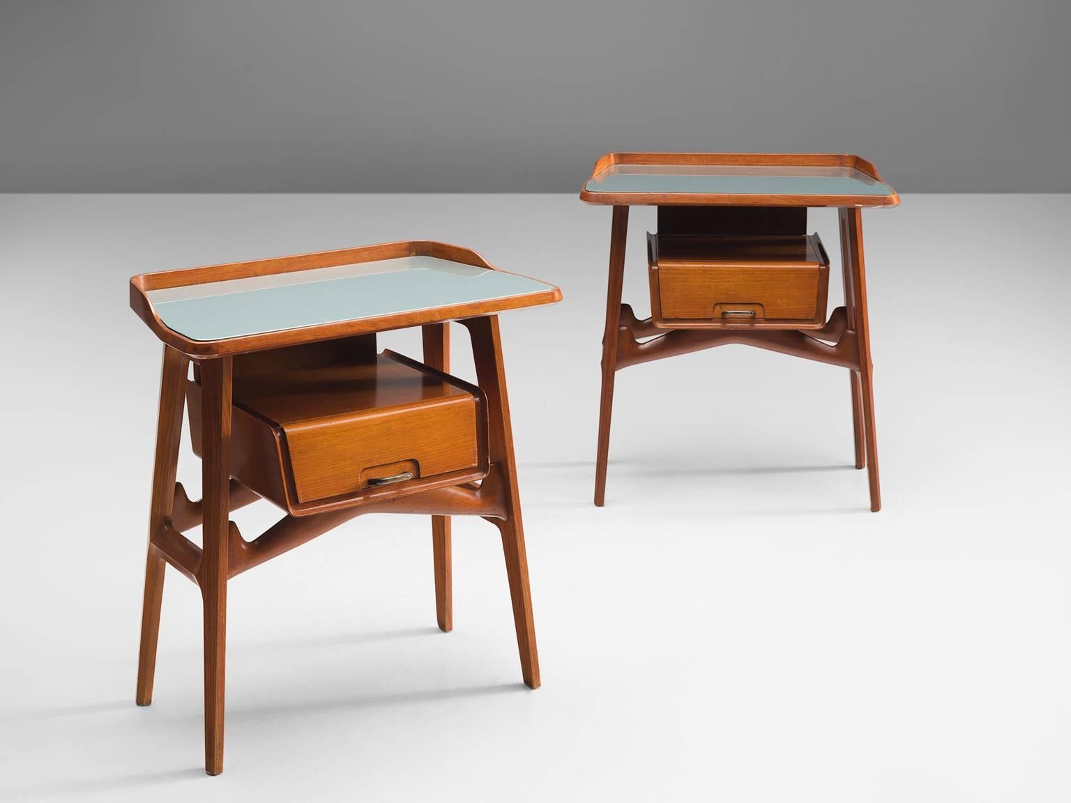 Side tables, fruitwood, glass, brass, Italy, circa 1950.

These two side tables or nightstands are both refined and elegant in every way. The glass top stretches a little but over the outer edges of the solid, precisely crafted legs. These
