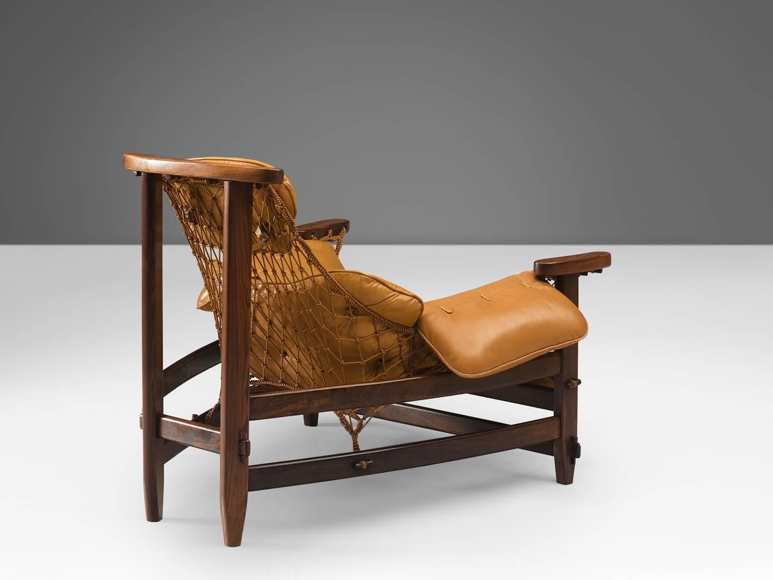 Jean Gillon, 'Jangada' armchair and ottoman, rosewood, nylon rope, leather, Brazil, 1968.

This robust and hefty armchair is designed by Jean Gillon. The originality of this Jangada comes from the concept of the body being captured by the piece of